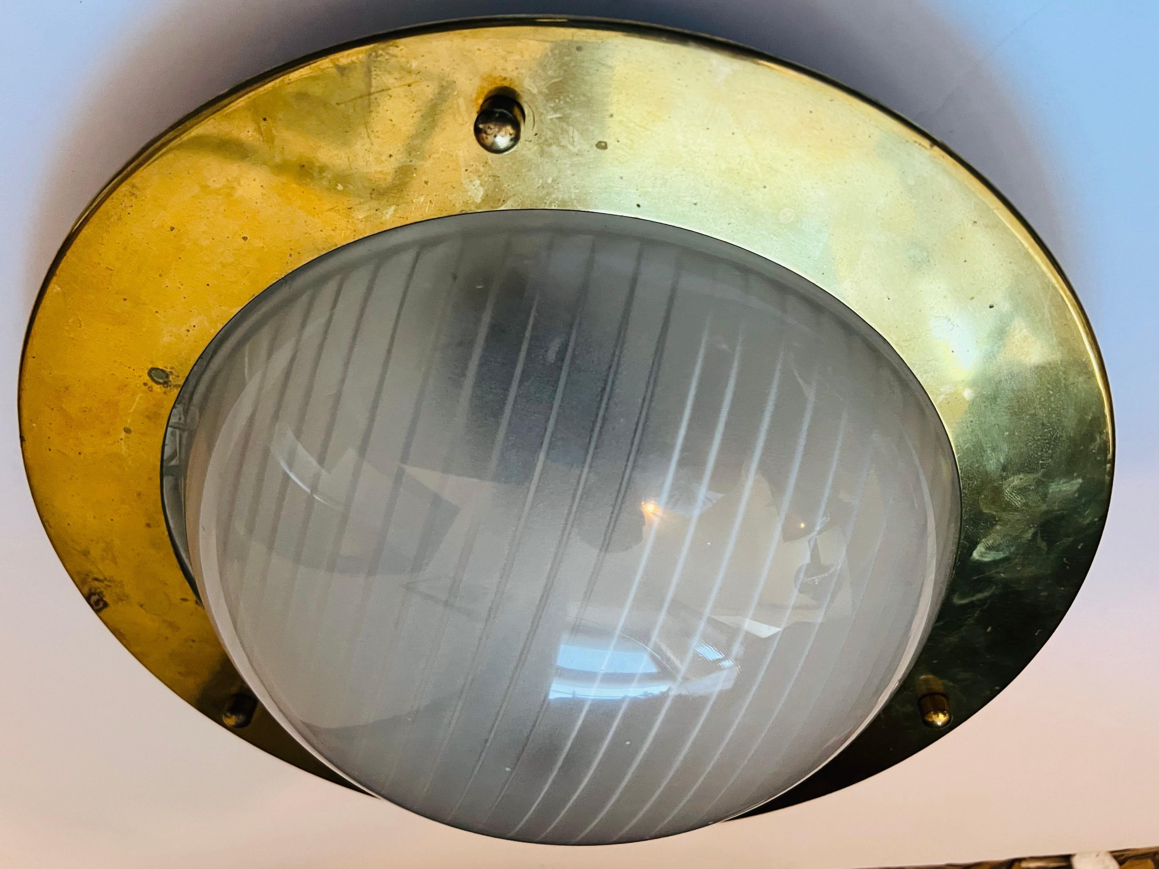 A 1960s nautical style golden brass ceiling fixture with a hallophane glass shade. Newly rewired.