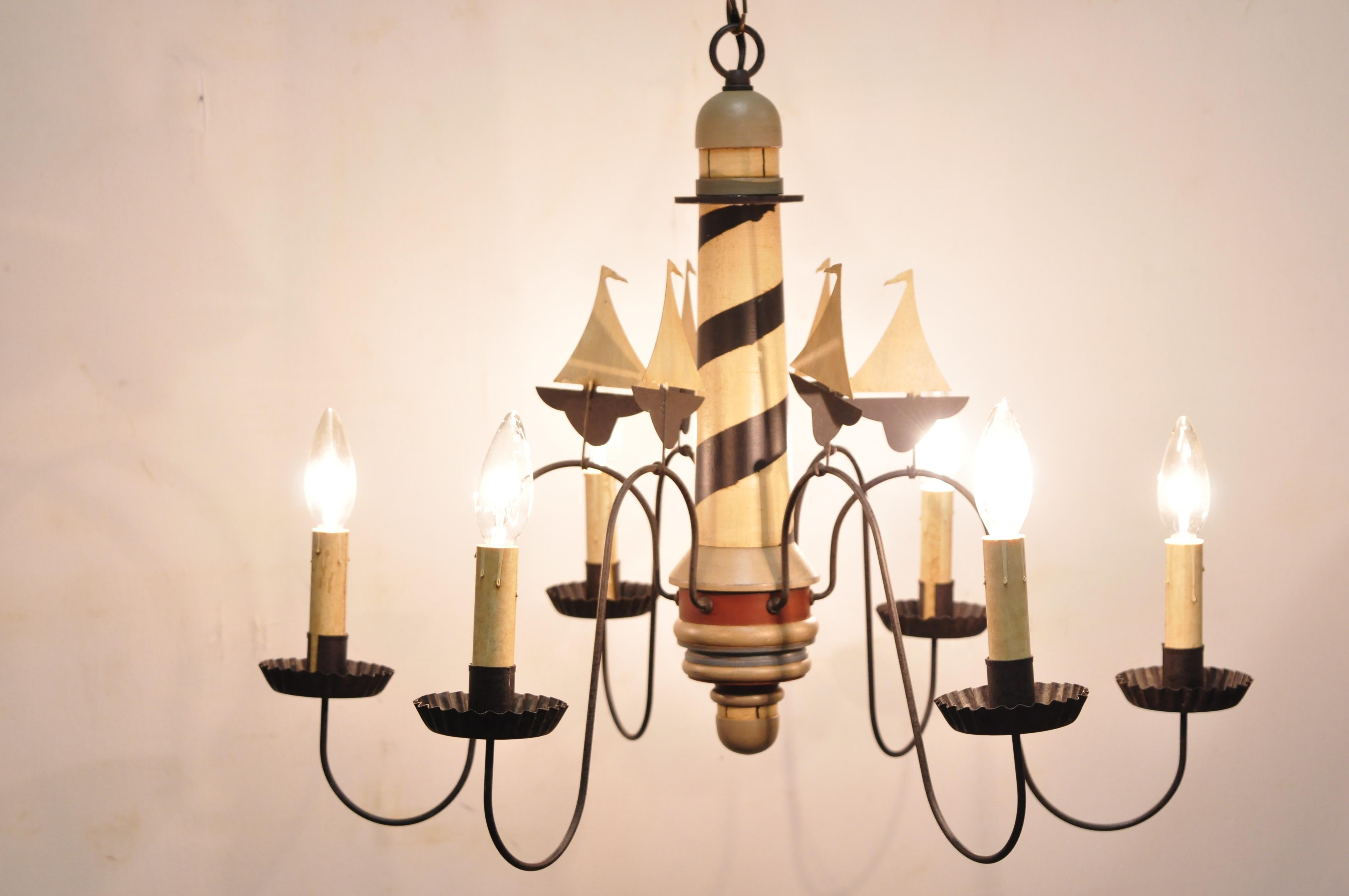 Nautical lighthouse and boat ship wood and metal chandelier light fixture. Item features iron arms, metal boat/ship accents, wooden lighthouse, great style and form, circa late 20th century. Measurements: 18
