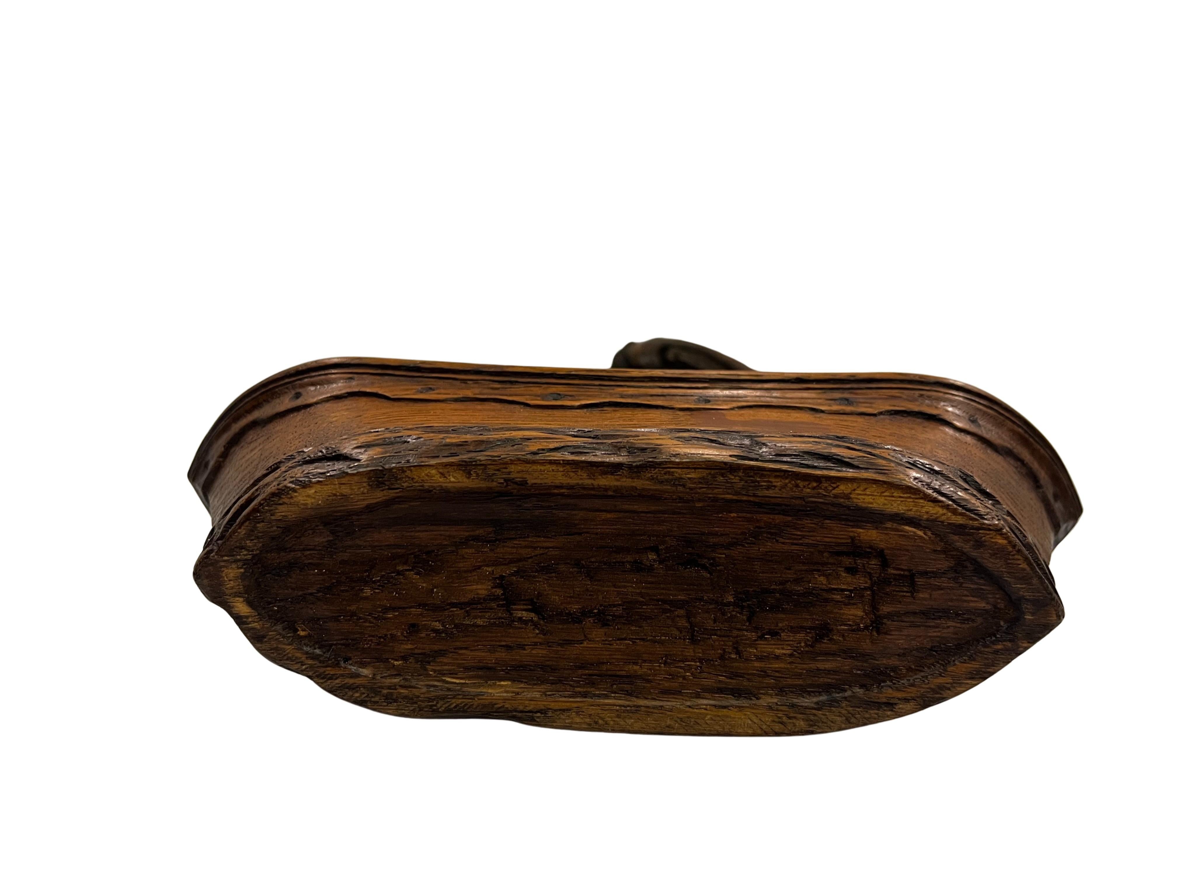 Particularly decorative pocket watch holder, made of hand-carved oak wood, manufactured around 1880 in Germany, probably in the Black Forest region.

An exceptionally charming watch holder designed in the shape of a sailing ship. The carver has