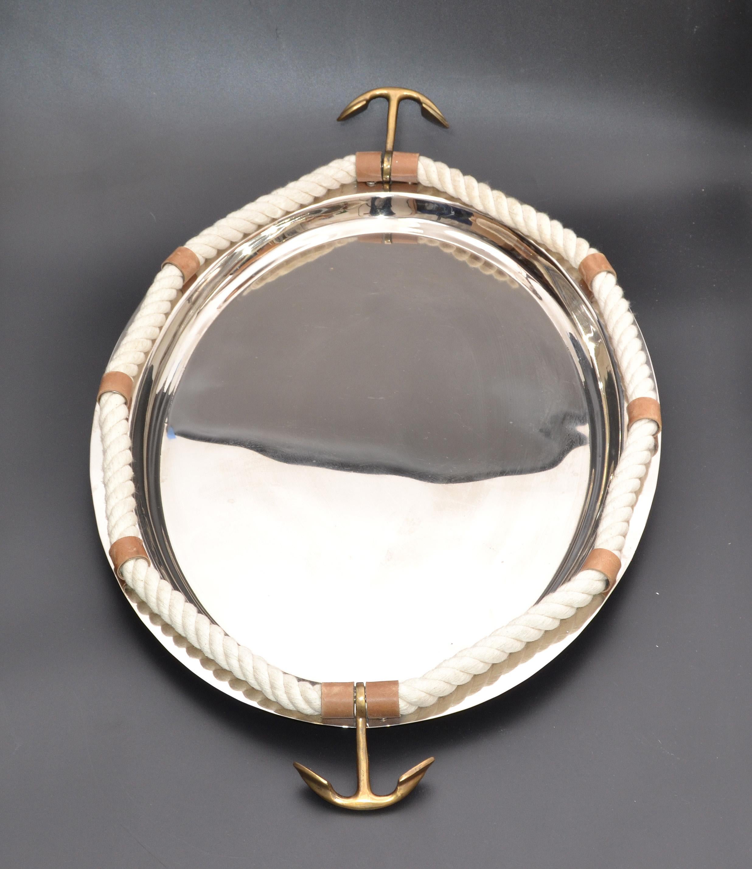 Mid-Century Modern nautical scene decorative serving tray or platter made out of stainless steel with bronze anchor handles decorated with rope and leather detailing.
 