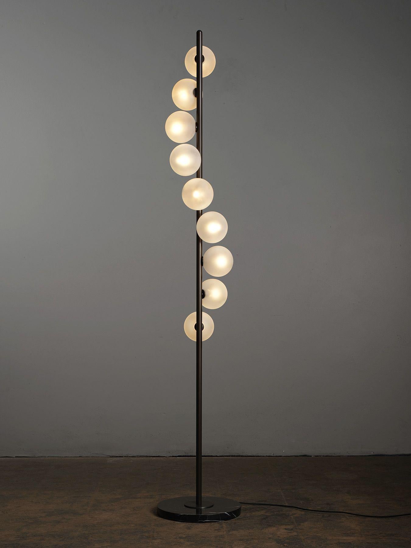 The Nautilus floor lamp by Blueprint Lighting is an elegant piece of functional sculpture that emits a stunning candlelit glow. Featuring satin glass globes spiraling downward, Nautilus is striking enough to be a focal point in a room, but compact