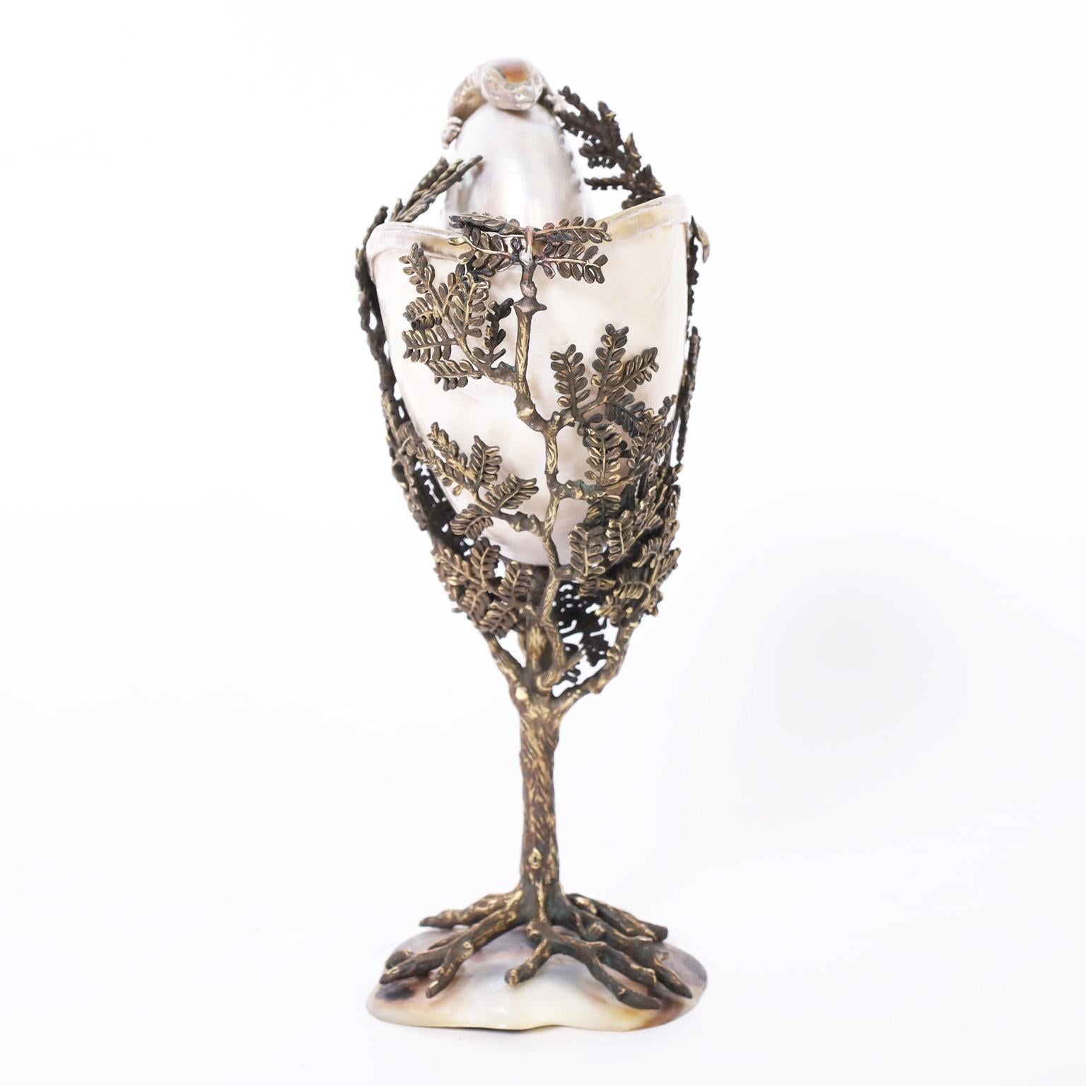 Intriguing vintage object of art with an eccentric composition having an organic nautilus shell in a cast metal tree on a penshell base featuring a silver plate lizard with a tortoise shell back.