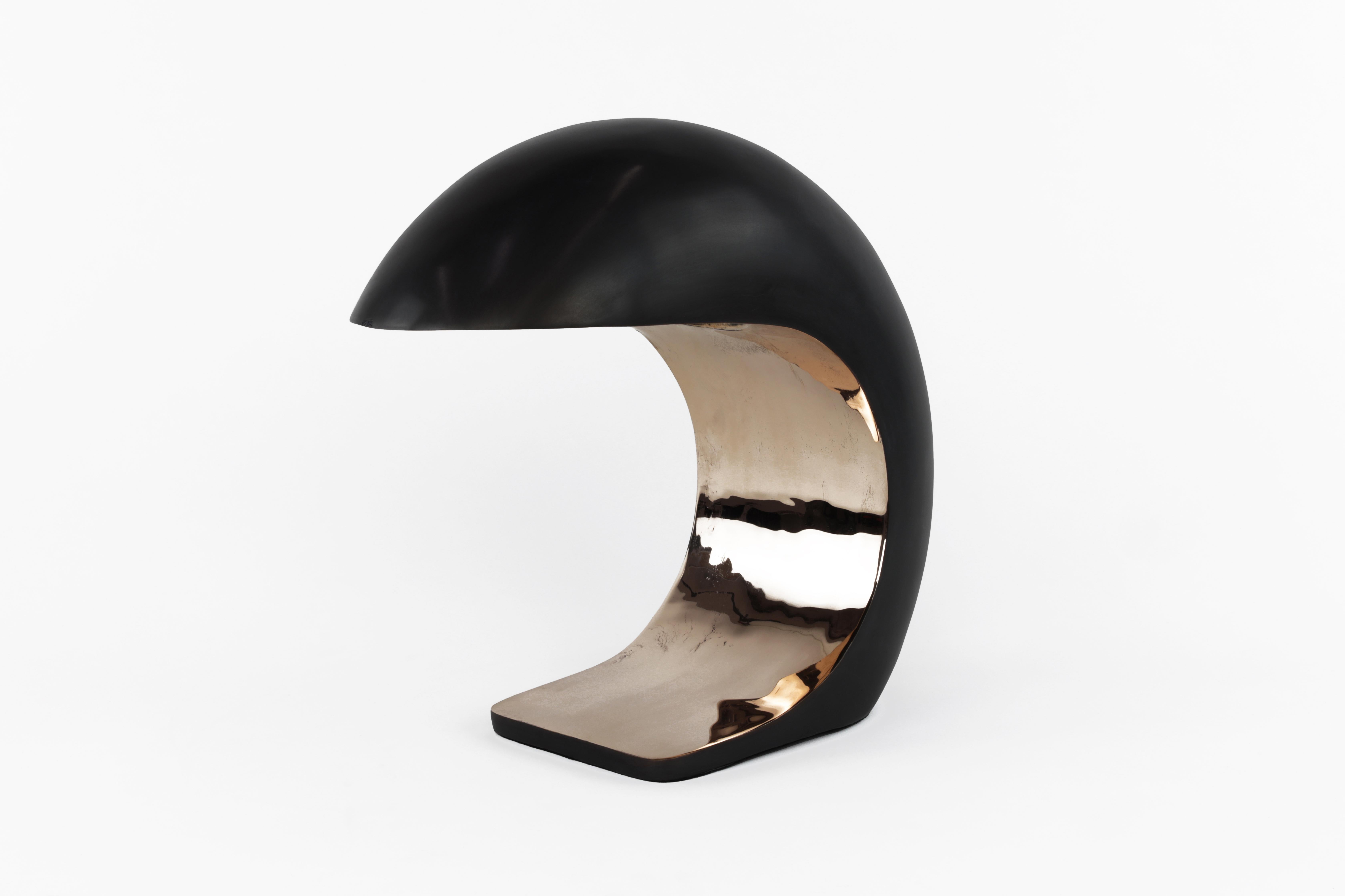 The (medium) NAUTILUS lamp is inspired by midcentury Italian design.
It is cast bronze and weighs up to 20 pounds. The outer shell has a blackened patina and the face is high polished to a mirrored finish.
 
The NAUTILUS illuminates by a three-way
