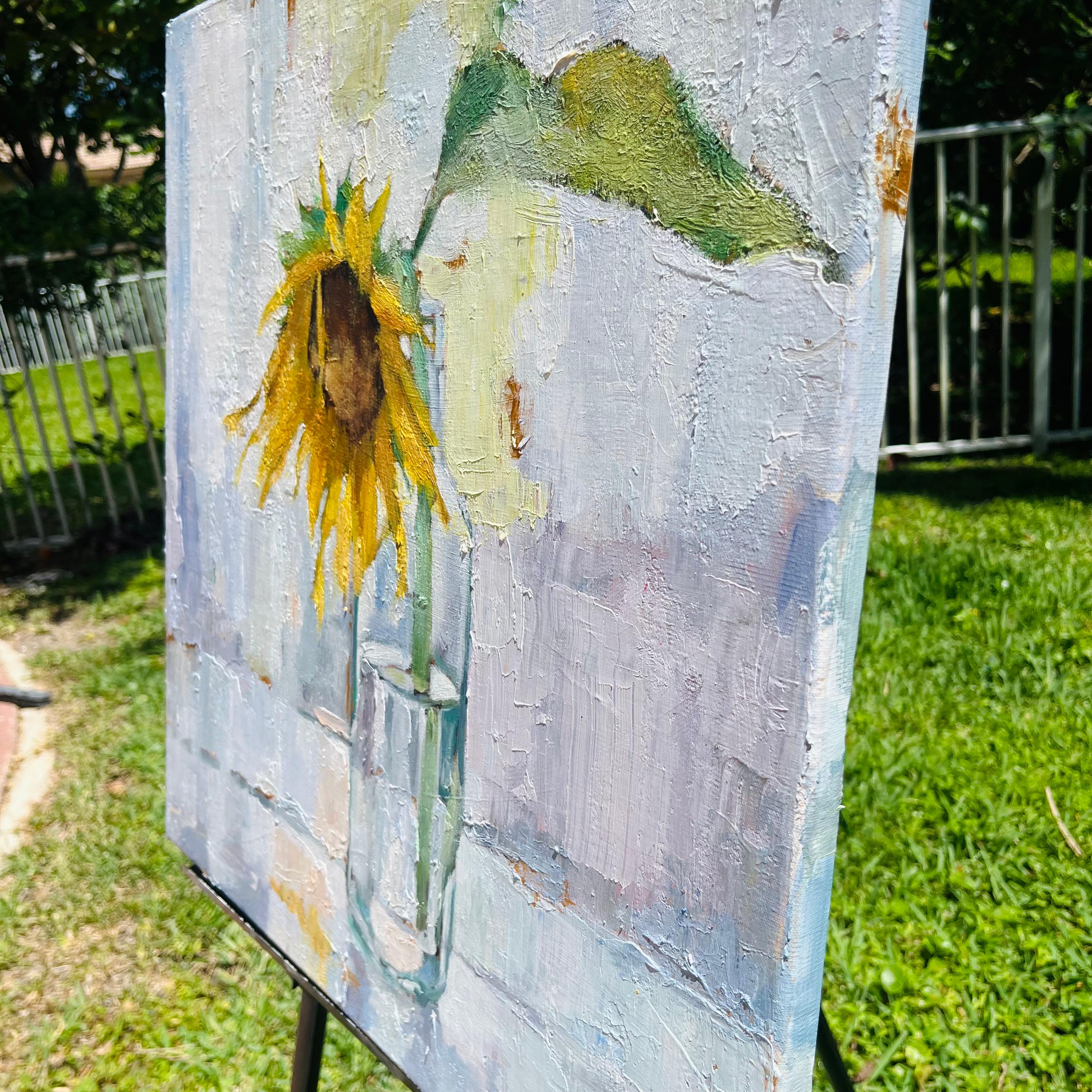 <p>Artist Comments<br>A single sunflower gracefully droops from a clear bottle. The textured impasto strokes accentuate its fragile form. Its vibrant yellow petals contrast against the serene neutrality of the background.</p><br/><p>About the