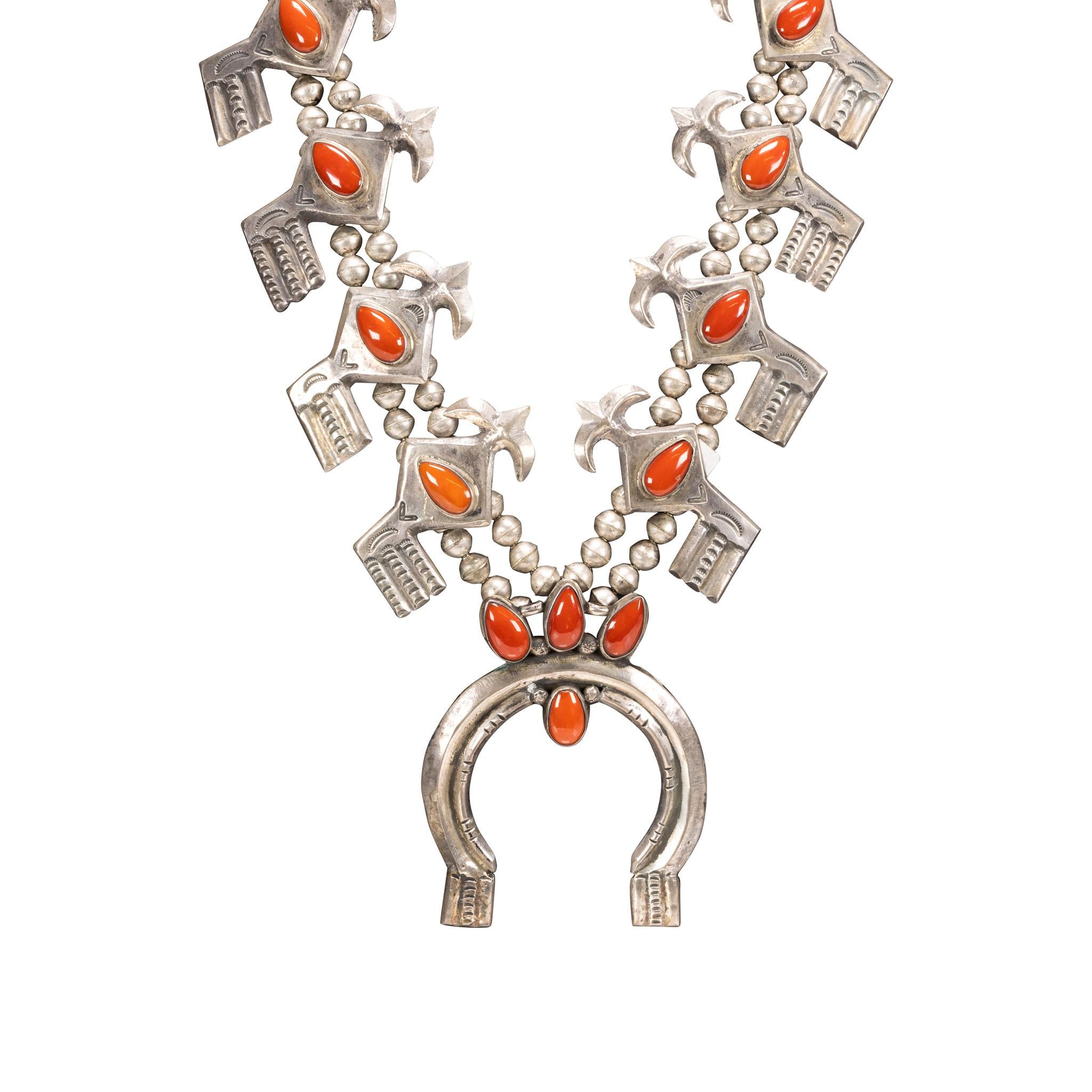 Coral necklace stylized squash blossom. Eight teardrop shaped coral stones set in stylized petals. Simple sterling naja with four coral stones on top. Old Pawn. From the Indian Store in Clovis, New Mexico. Great for formal or casual Southwestern
