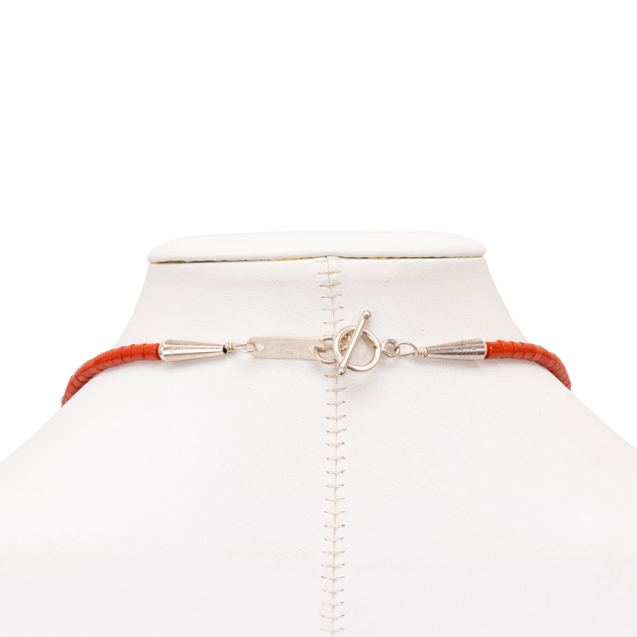 Native American Navajo Indian coral necklace by Doreen Lebya, Navajo. Coral bead necklace with flat beads connecting at the sterling barrel bead. The beads are all round and uniform. The 6 strands are the same length and lay intertwined. Sterling