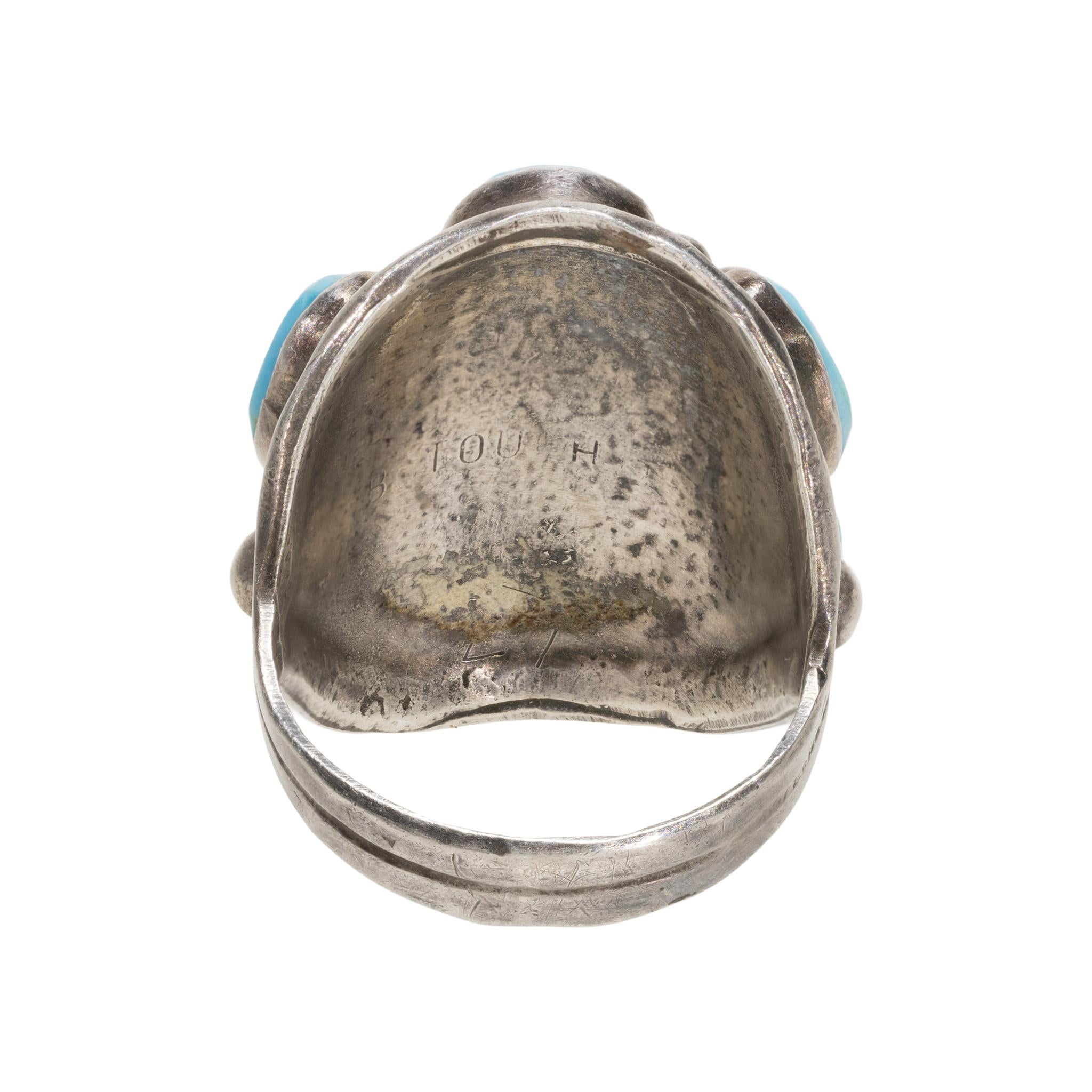 Navajo Bisbee turquoise and sterling ring. Seven turquoise nuggests interspersed with sterling beads surrounded by hand stamped detail. Maker's mark 