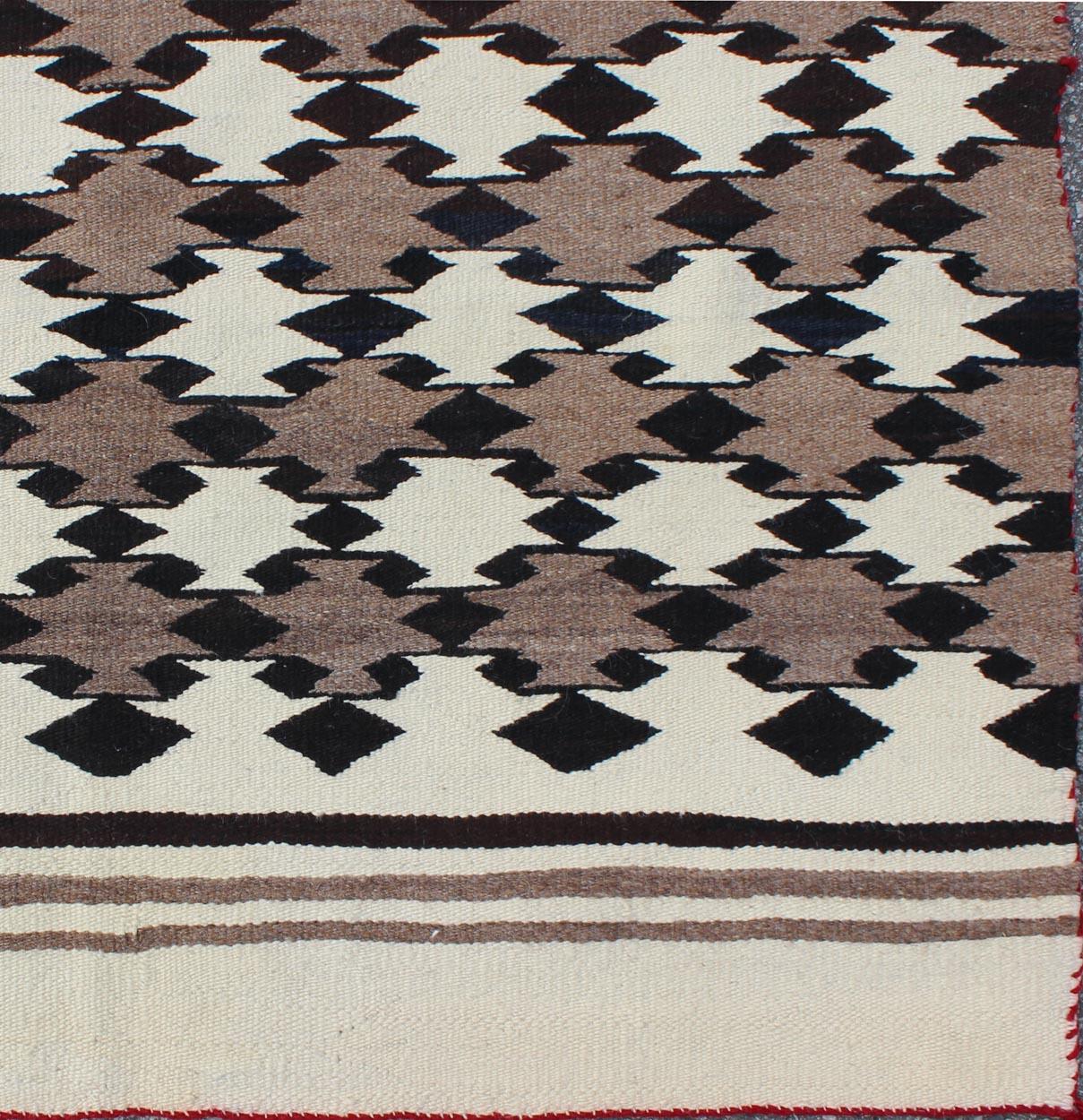 American Navajo rug with latticework tribal design, rug I-1101, country of origin / type: North America / Navajo, circa 1950 early 20th century.

Measures: 3'3'' x 5'2''.

This intriguing Navajo rug was woven in the United States during the