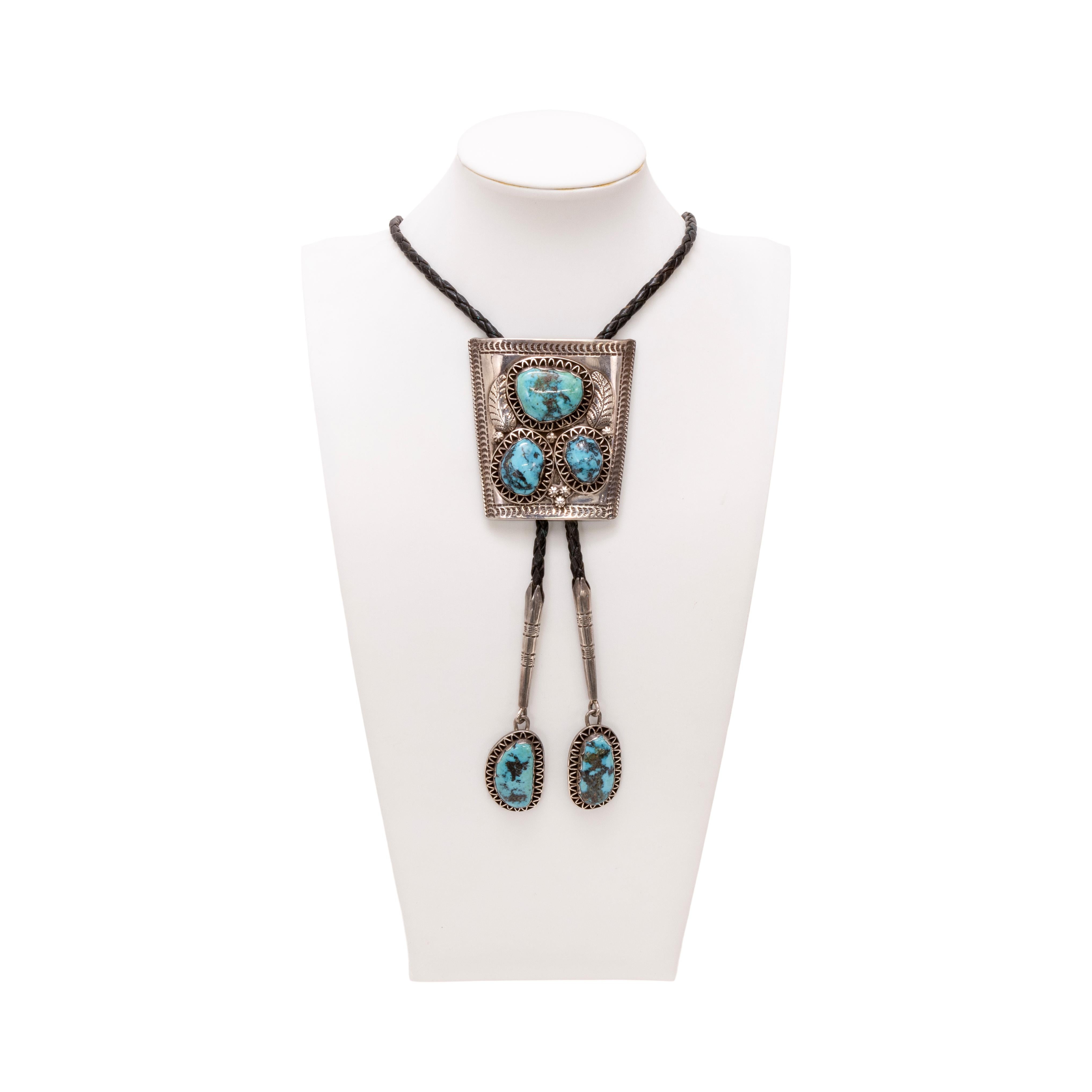 Navajo bolo with three set stones with zigzag edging and silver feather overlay accents, as well as matching stone drops to long tips. Bolo 3