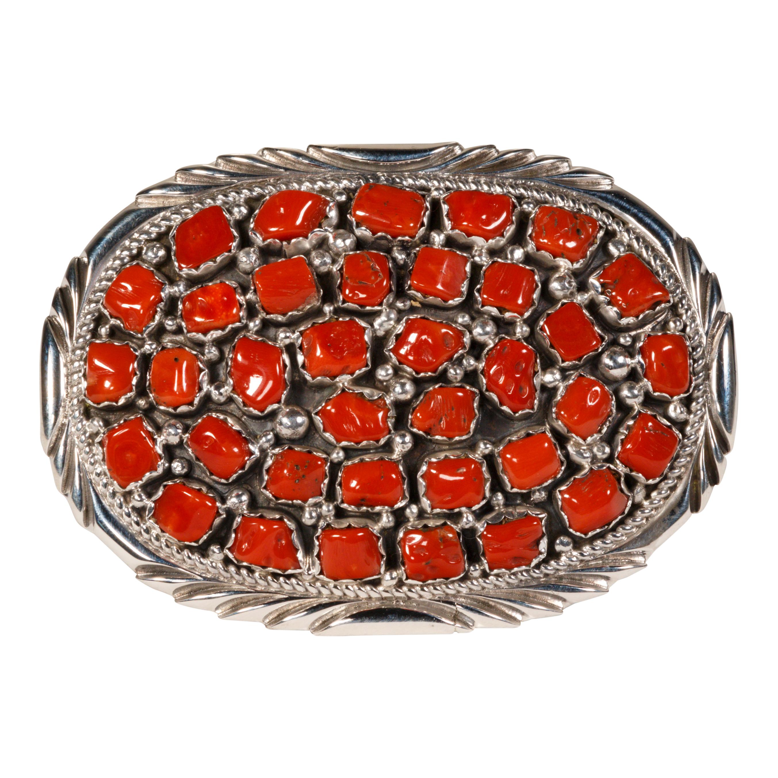 Shadowbox belt buckle with multi coral nuggets. Marked sterling silver. Made by Navajo silversmith J. Begay. Stunning oxblood coral stones surrounded by twisted rope border and sterling beads. 

PERIOD: Last Half 20th Century
ORIGIN: Southwest -