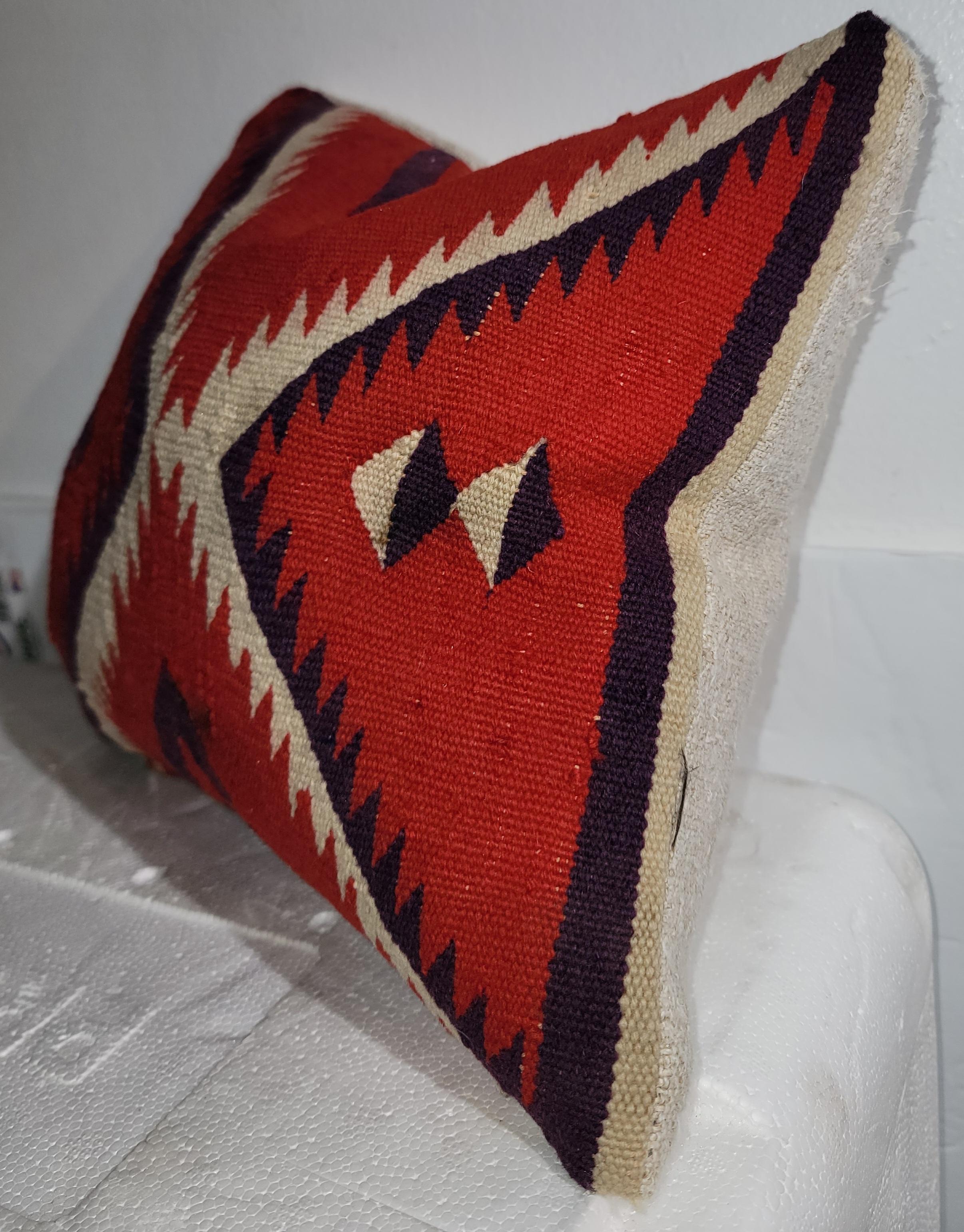Navajo Deep Red Double Eye Dazzler Pillow Sampler.

This pillow was made from a larger double eye pillow. The blueish and off white jigsaw patter flows through the center of the pillow from the corners meeting at a single pint in the center