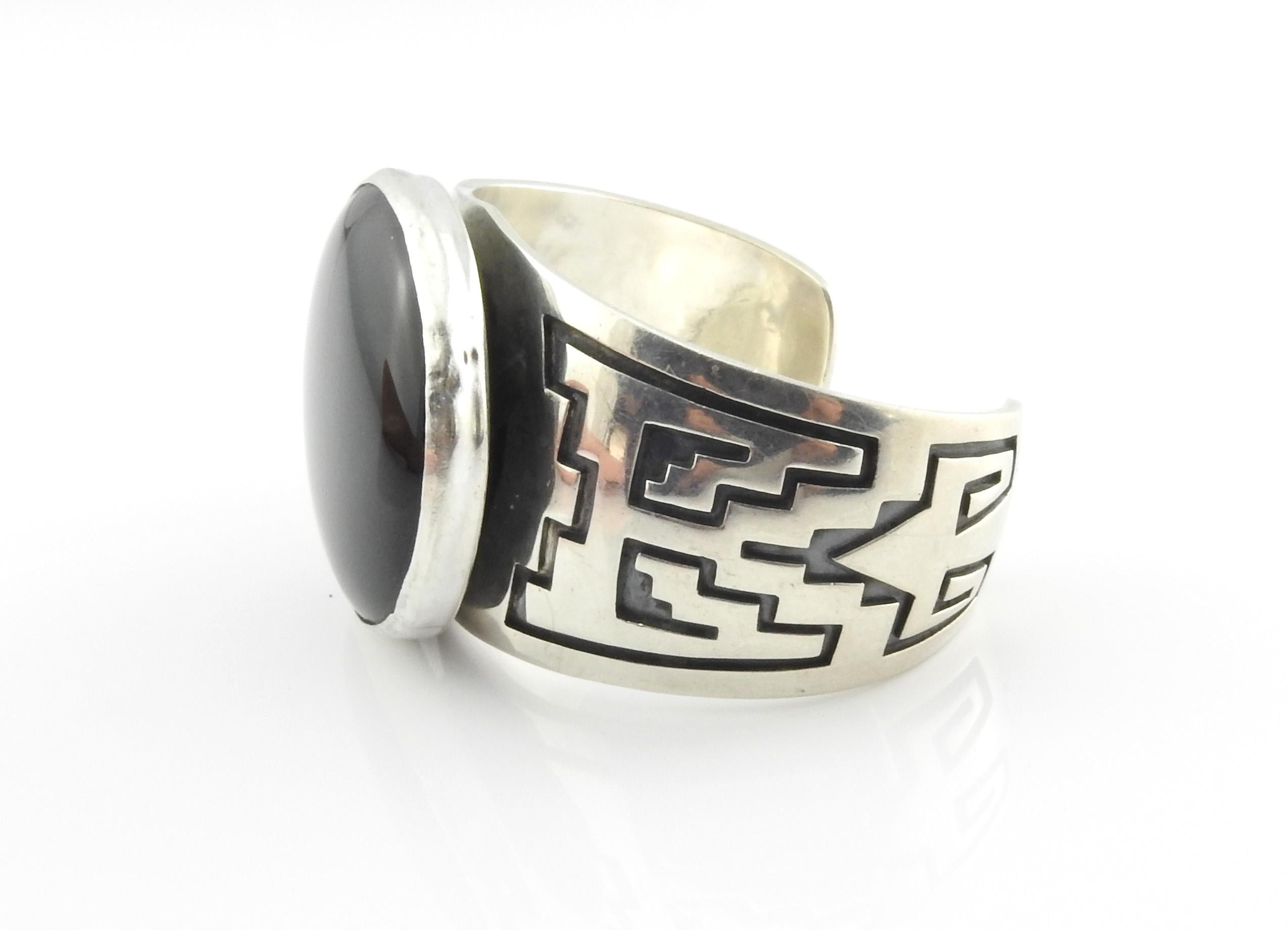 Native American Navajo Everett and Mary Teller stamped sterling silver and black onyx cuff bracelet.

Marked: EMT in fish design mark, Sterling

Measures: 5 1/4