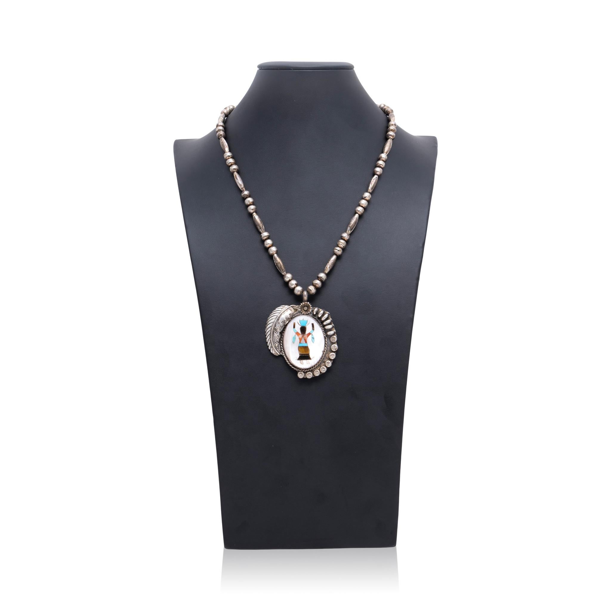 Native American Navajo Indian dancer multi inlaid stone necklace. Large pendant with mother of pearl background including amber, onyx, spiny oyster, and turquoise dancer figure in center. Framed by twisted rope border, stamped sterling beads, and