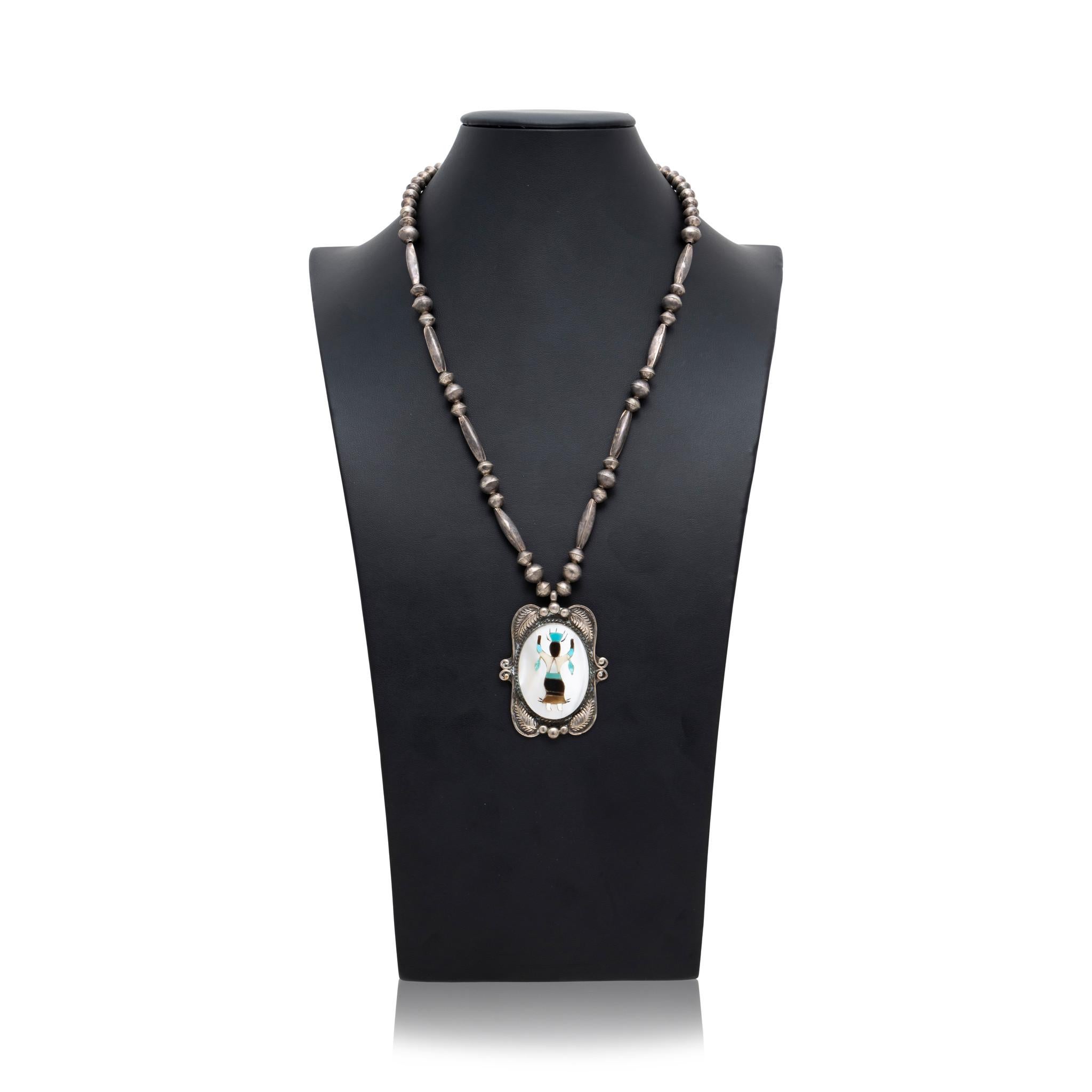 Native American Navajo Indian dancer multi inlaid stone necklace and bracelet. Featuring a large pendant with mother of pearl background including amber, onyx, spiny oyster, and turquoise dancer figure in center. Framed by twisted rope border,