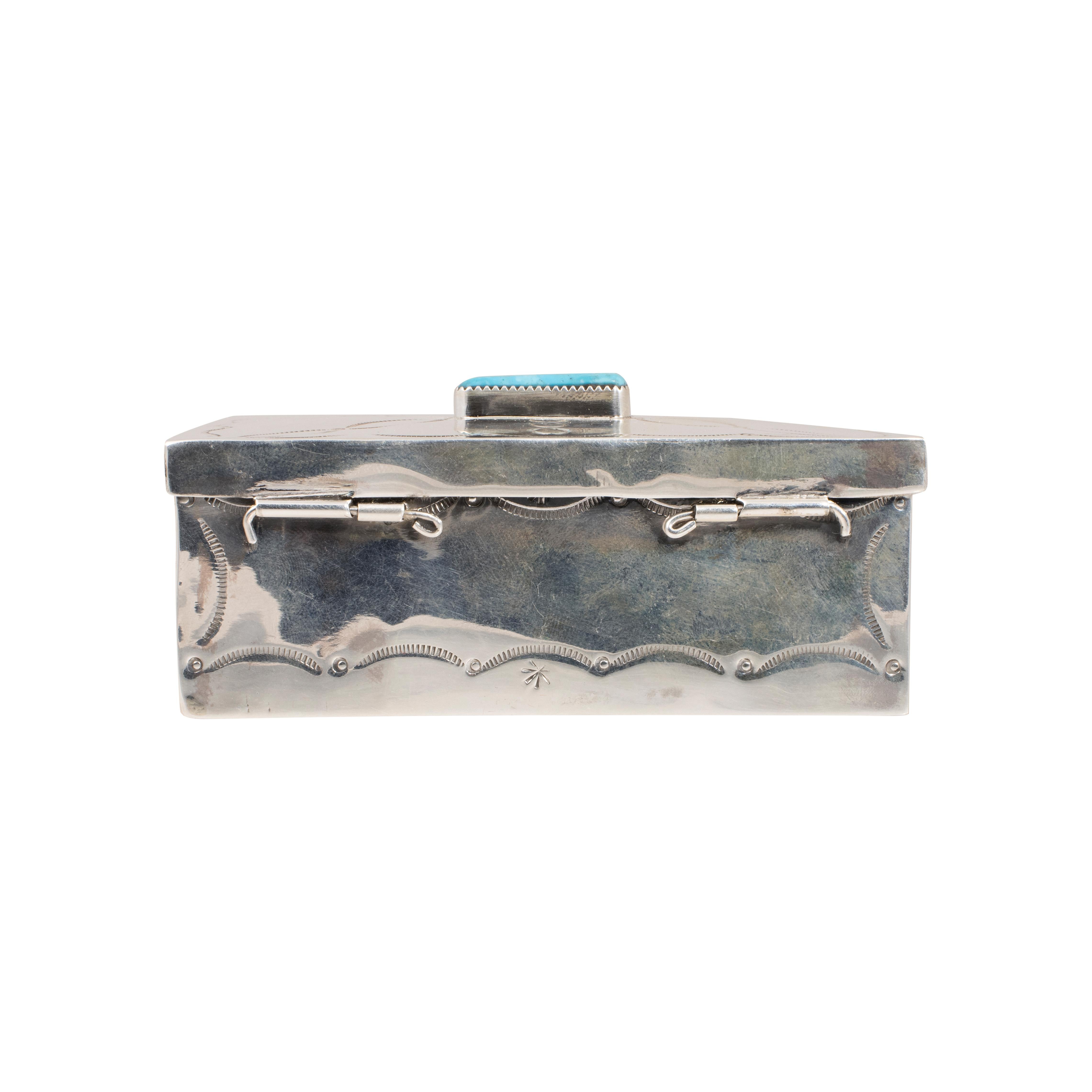 Navajo  sterling silver and Fox turquoise box. This box has an amazing finish and styling that resembles the Navajo stamp work of the early 1900’s. On the top is a nice size, polished cabochon of Stormy Mountain turquoise, showing a blue-green