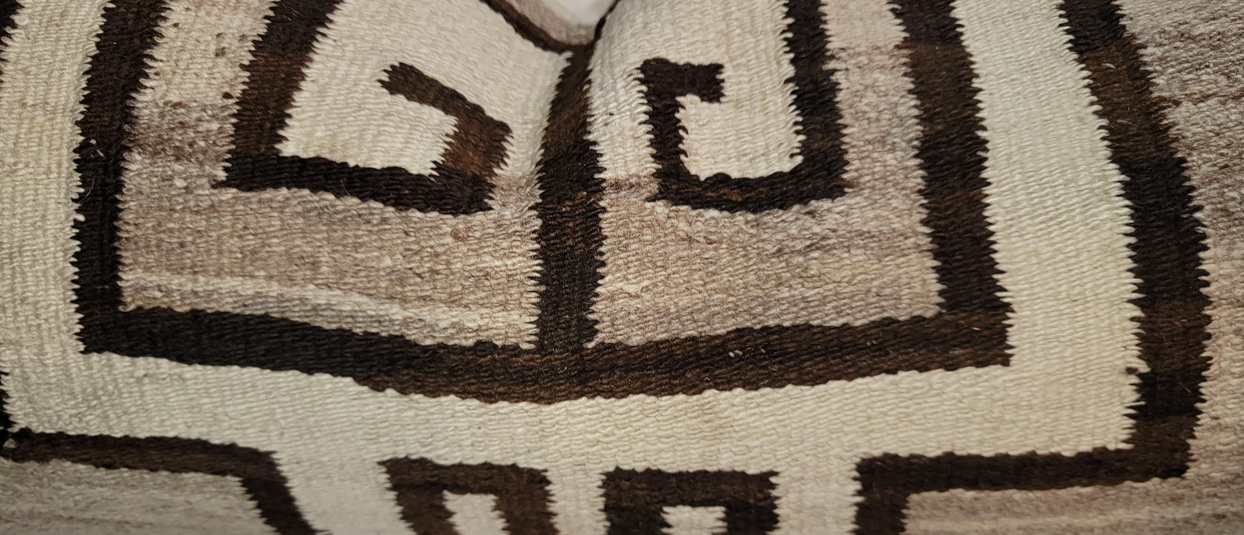 Navajo Geometric wool pillows with natural neutral colors. 
The wool on this patter is a tight knit wool with hand dyed dark browns. 
Linen backing and down and feather inserts.