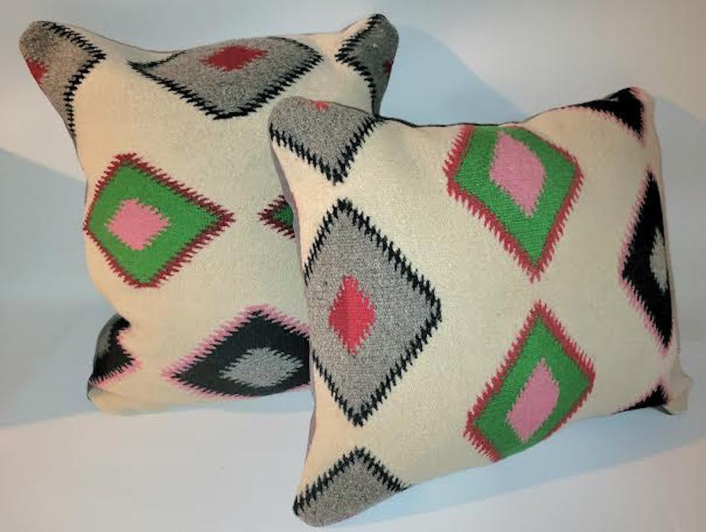 Pair of Navajo Indian Eye Dazzler custom made pillows.
Beauttiful bright colors. (Off White, Pink, Green, Gray, Red, and Black) Greay Suede backing. New feather and down inserts.