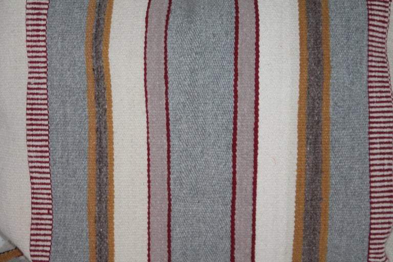 This fine handwoven Navajo Saddle blanket monumental pillow is in fine condition with the original corner ties. The backing is a taupe cotton linen. The insert is down and feather fill.