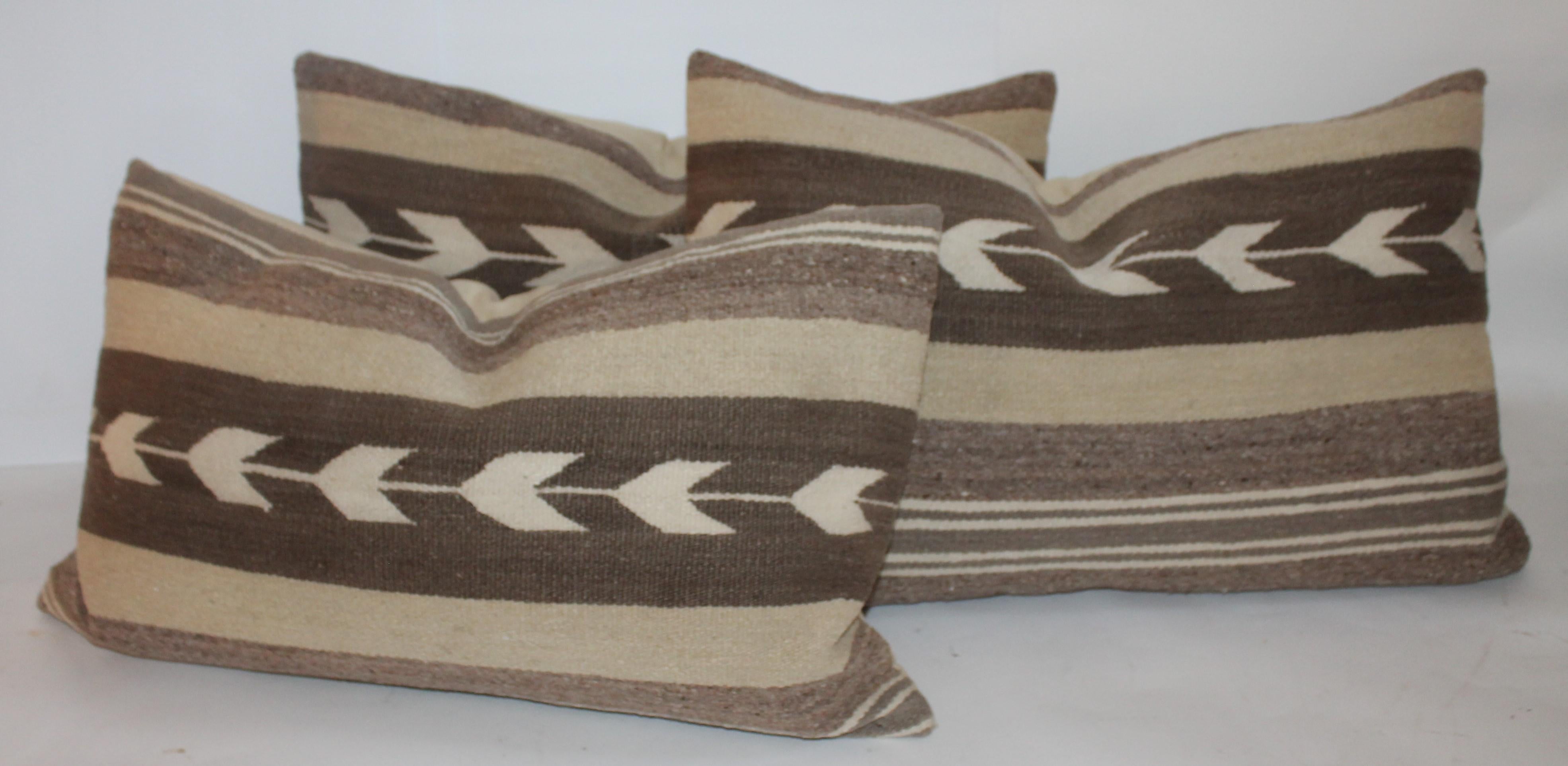 These fine and pristine Navajo Indian weaving bolster pillows are in great condition. Sold as a group of three. Tan cotton line backings.