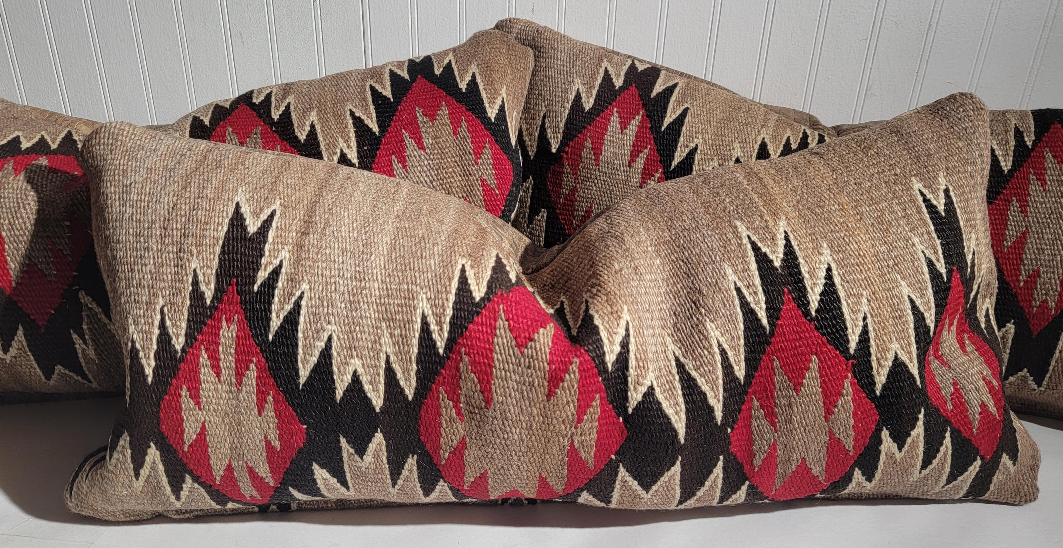 19Thc Navajo Indian weaving bolster pillow with alligator print leather backing. The filling is down & feather fill. These are sold individually.

Largest pillow measures - 31 x 14
both smaller pillows measure - 30 x 12

Each pillow is priced - $975