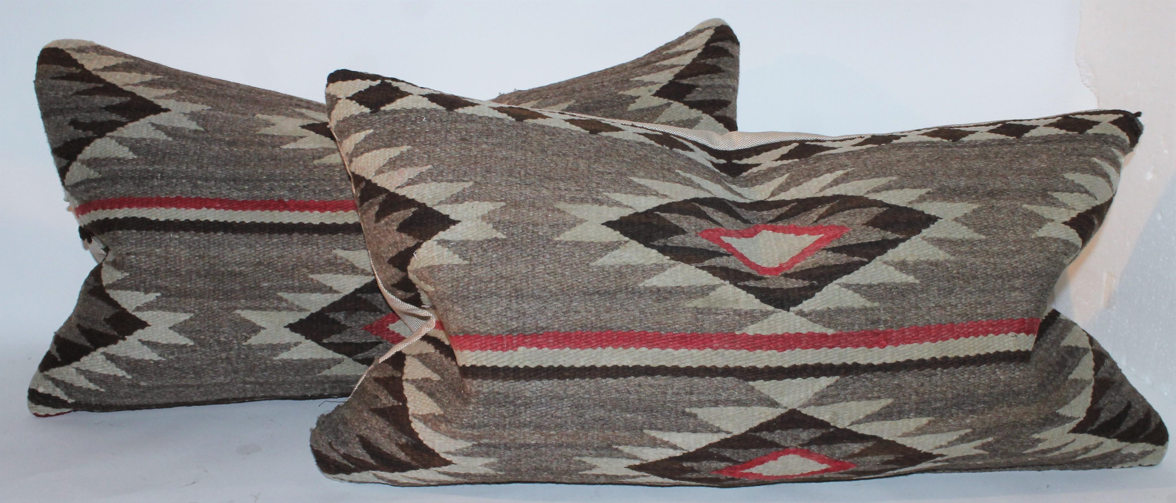 These large Navajo Indian weaving eye dazzler bolster pillows are in fine condition. Sold individually.