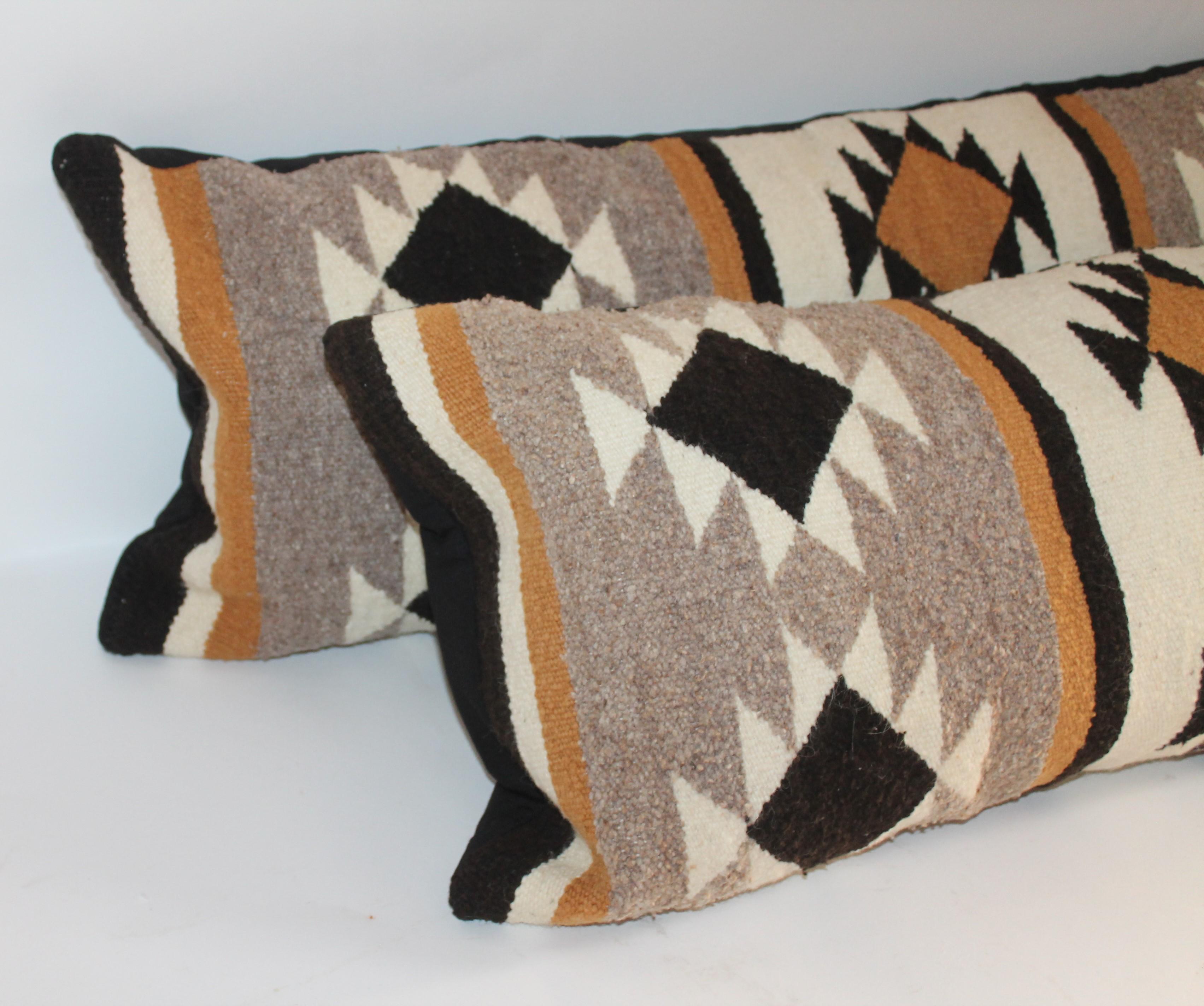Pair of Navajo Indian weaving bolster pillows in fine condition. The backing is in cotton linen backing.
