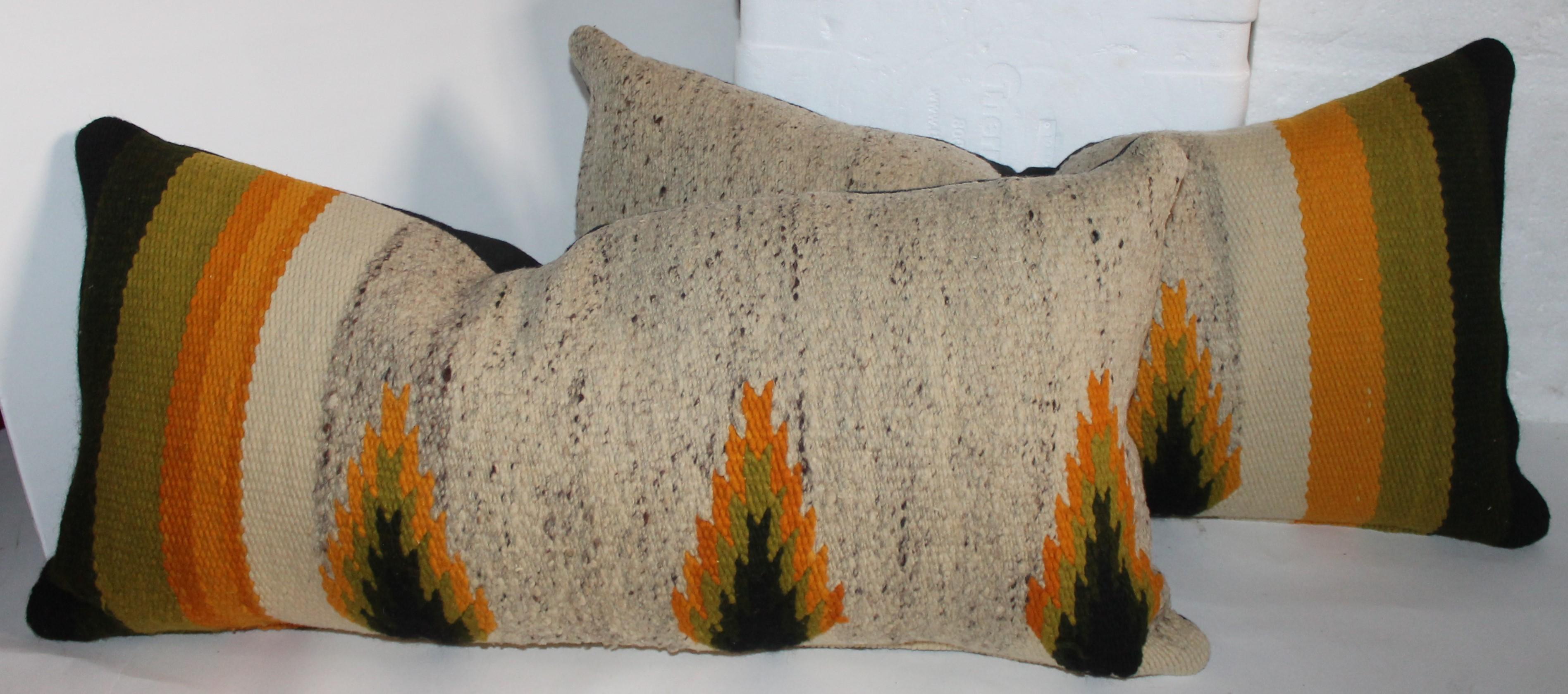 Navajo Indian weaving bolster pillows sold in pairs. There are two pairs of these weaving pillows. The colors are like Indian sunset.