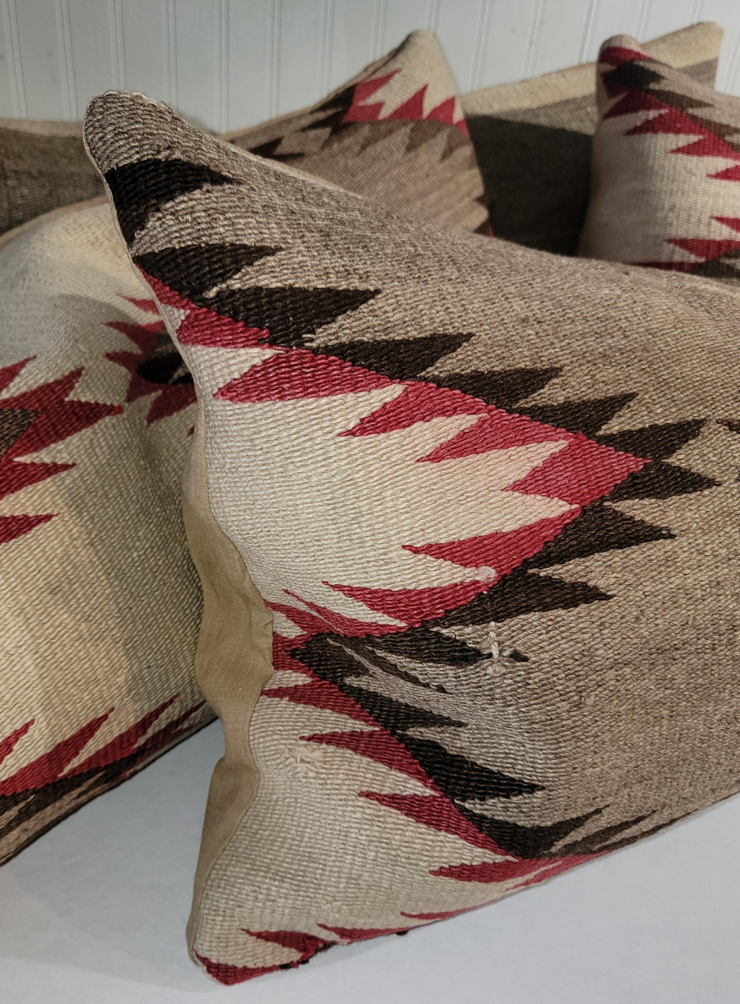 These early Navajo Indian weaving bolster pillows are in fine condition. The backings are in cotton linen & down & feather fill. Sold in pairs.  Two pairs are available in stock.