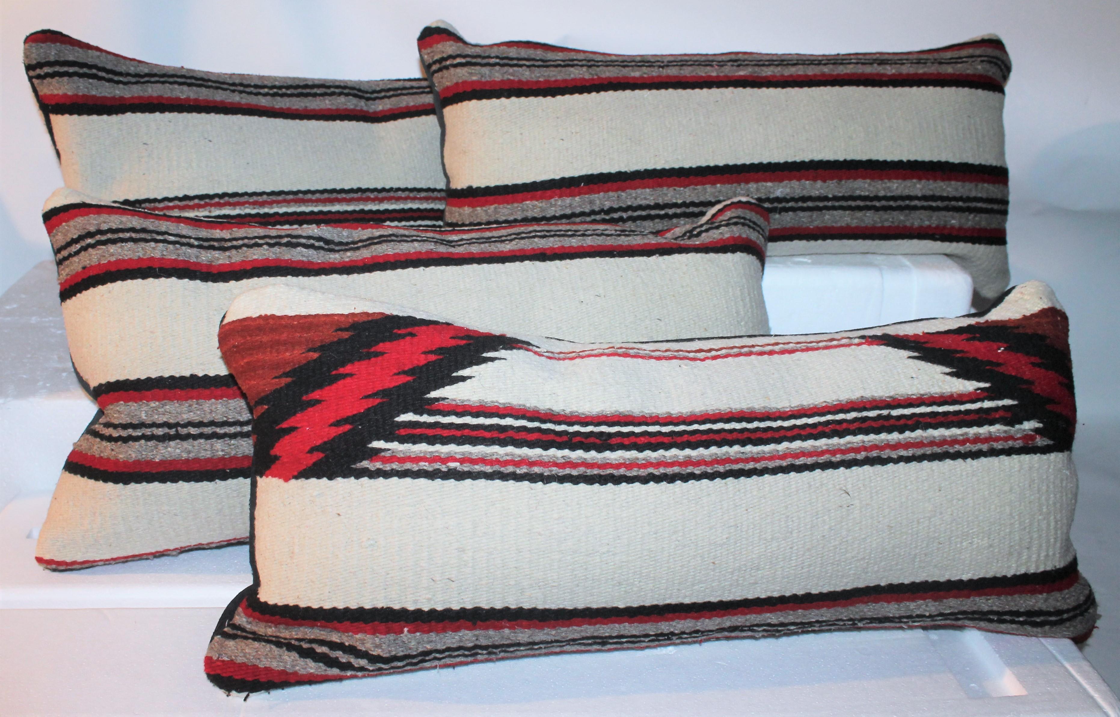 These fine saddle blanket Indian weaving bolster pillows have black suede / leather backings. The condition are very fine. Sold in pairs.
