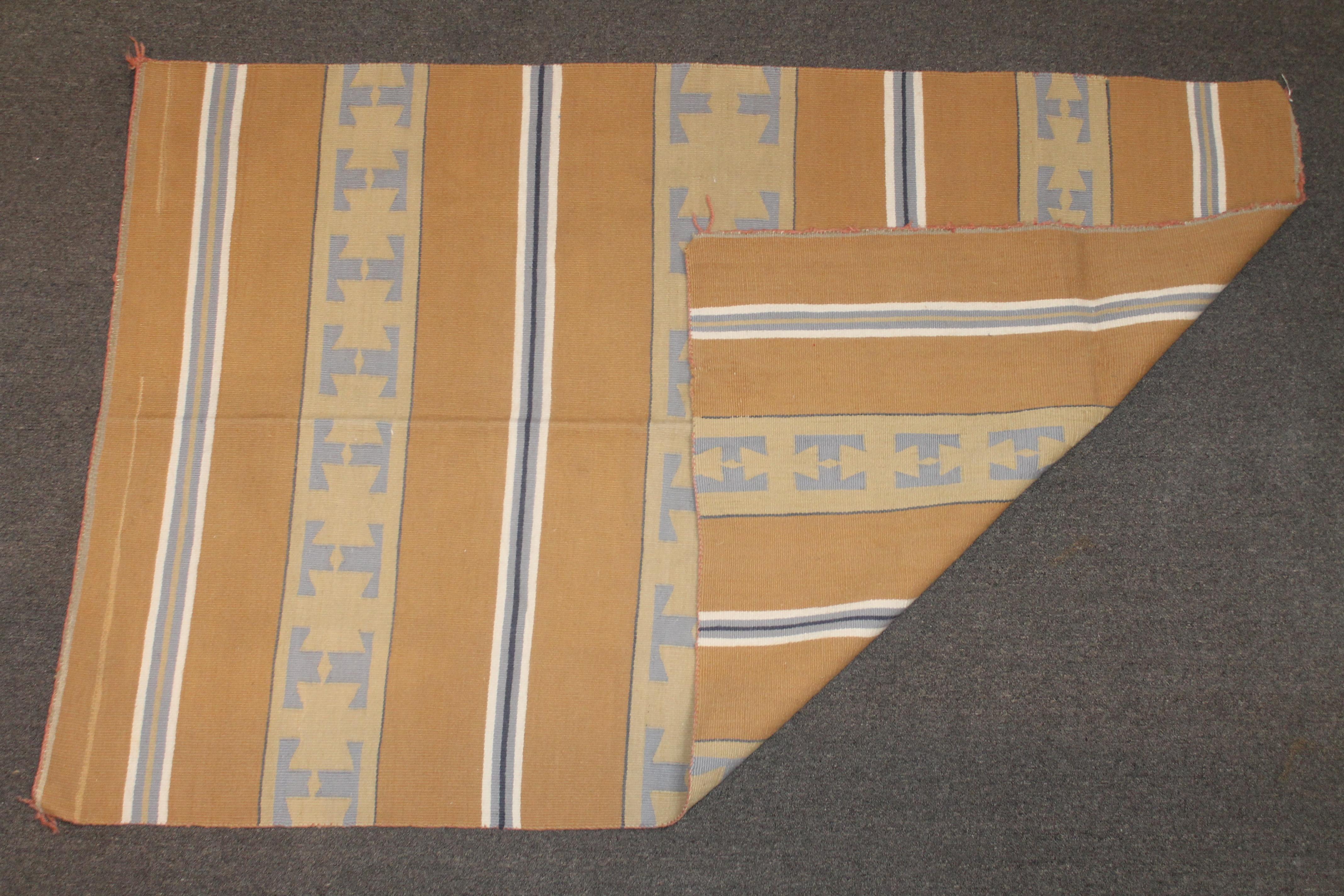 This Navajo Indian weaving from the Chinle Arizona Indians is in fine condition. Minor wear on one edge but not noticeable to the naked eye. This large area rug is simple yet rich mustard colors.