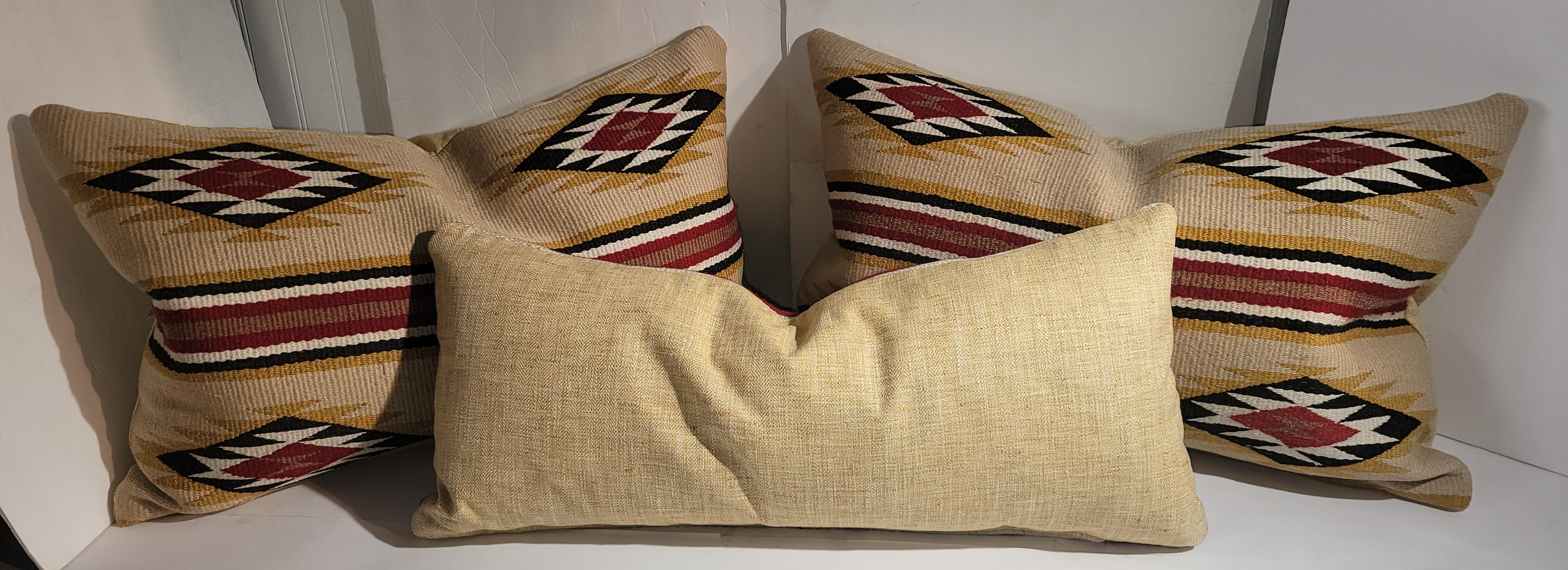 These Navajo Indian weaving pillows are Chinlies and all have yellow linen backings.The inserts are down & feather fill. All in fine condition. Sold as a group of three pillows.

largest pillows measure 27x 16.5 each 
smaller pillow measures 27 x 11