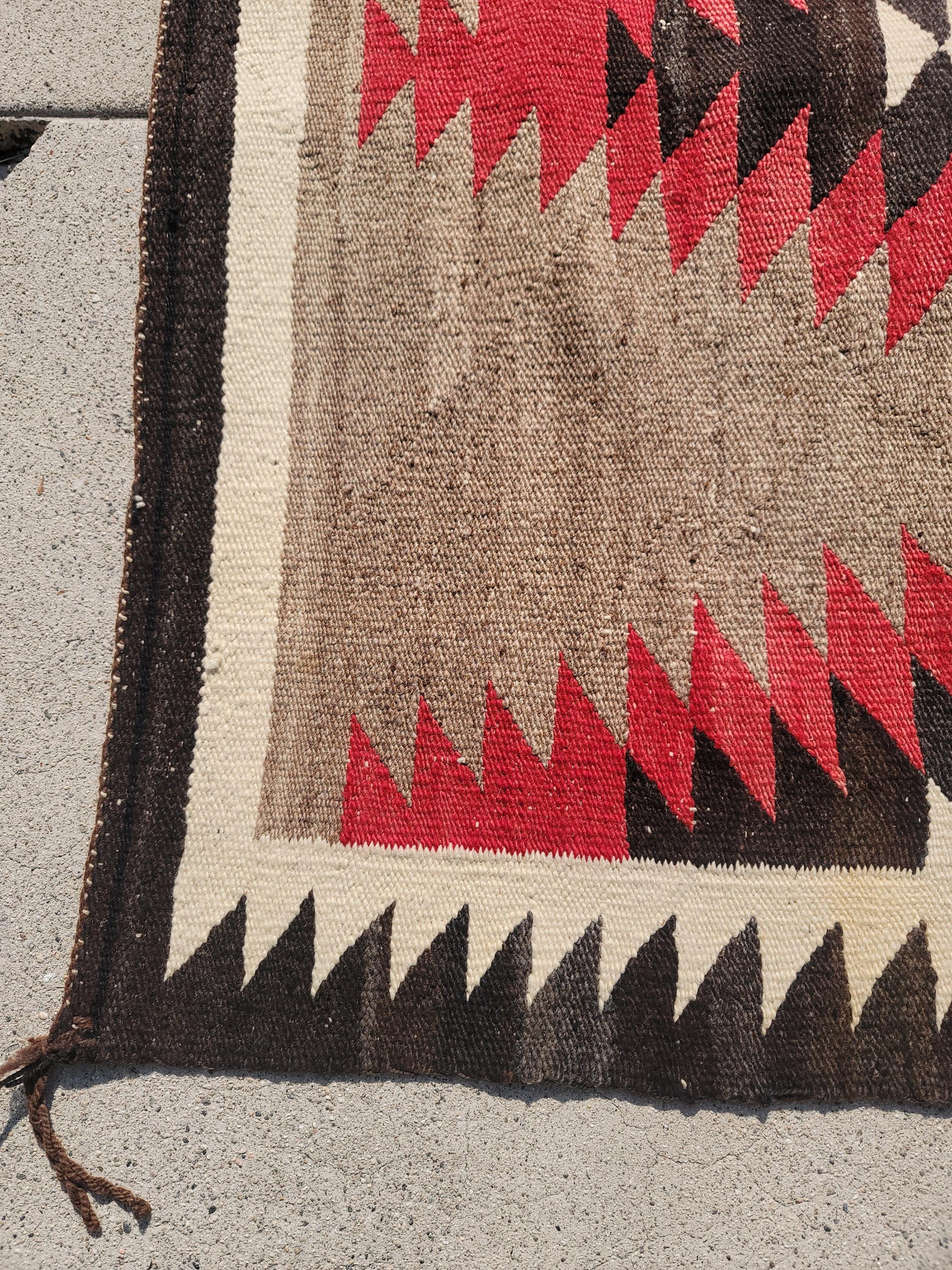 This hand woven Navajo Indian weaving in an eye dazzler pattern is in pristine condition. Great on the wall or floor.