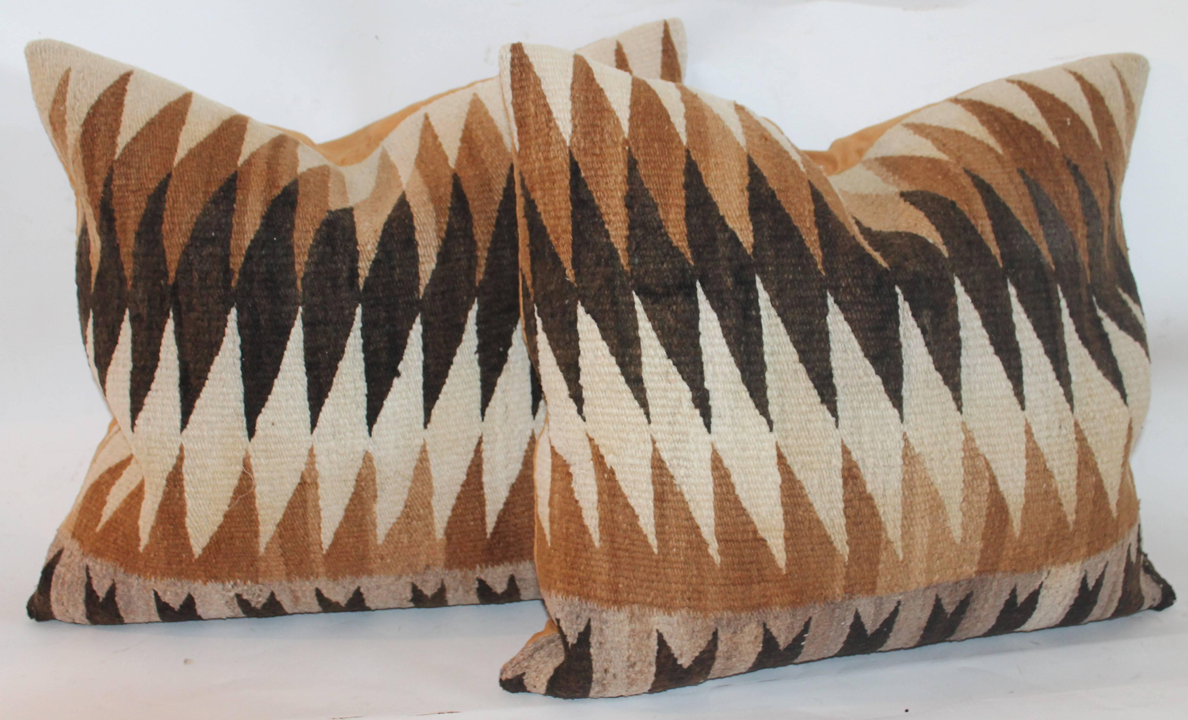 These early eye dazzler Navajo weaving pillows are in fine condition and have mustard cotton linen backings. Sold as a pair only.
