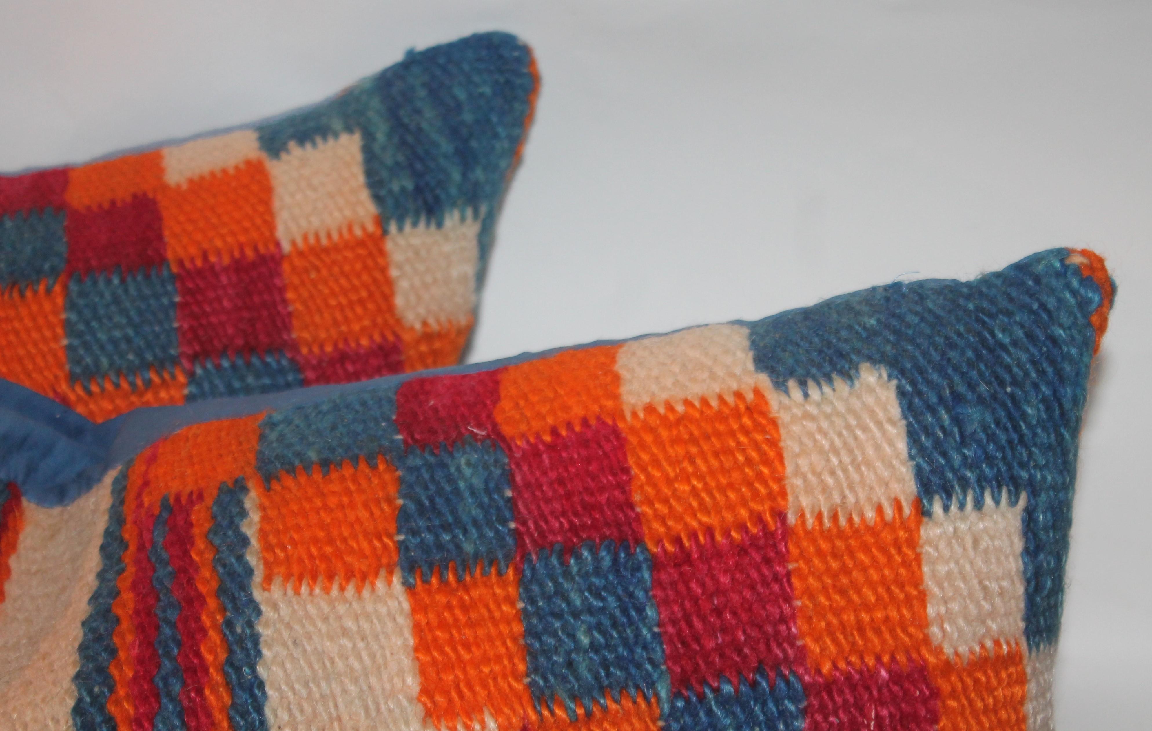 This fine pair of colorful Navajo Indian weaving saddle blanket pillows have blue linen backings. Sold as a pair.