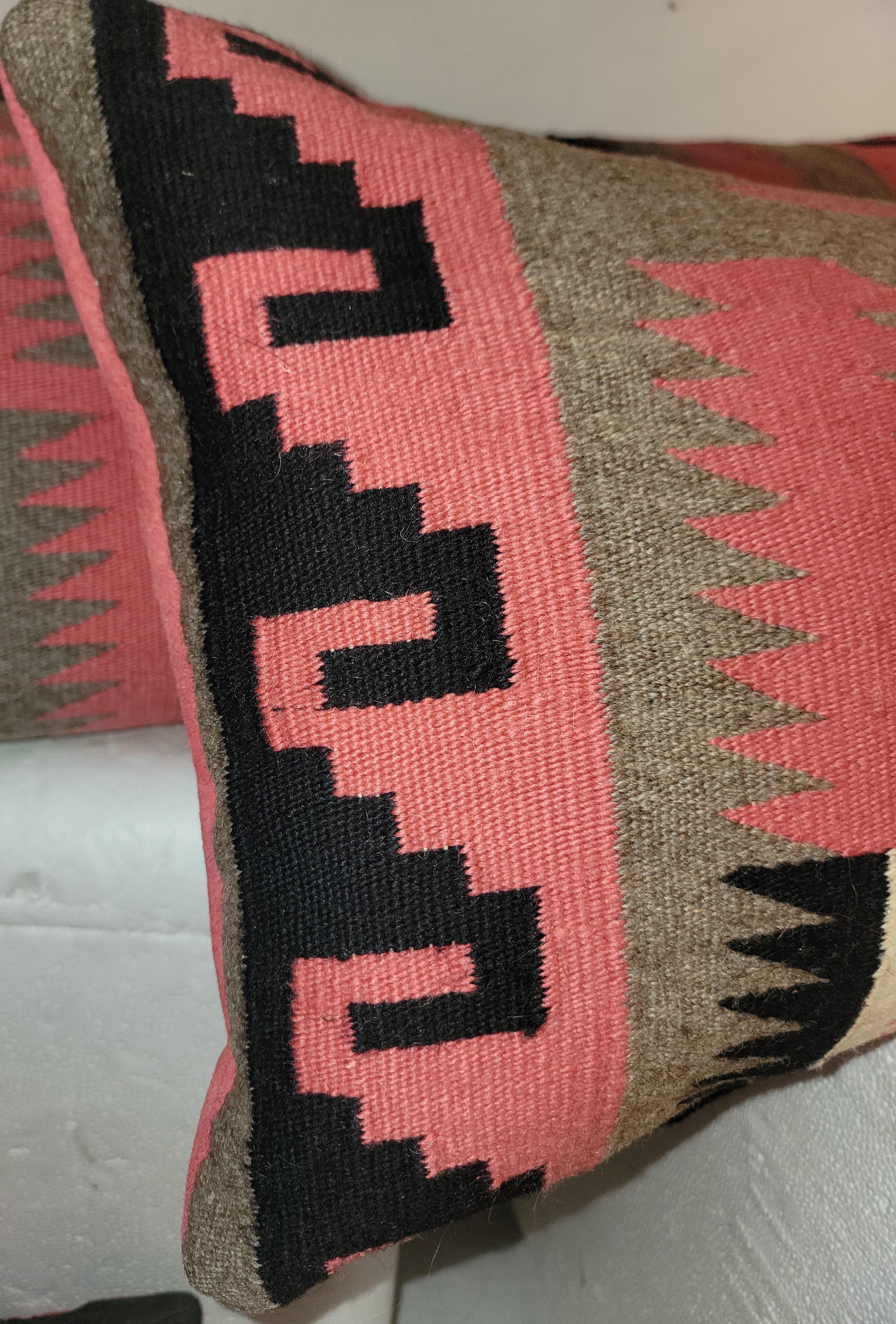 These amazing Navajo Indian weaving bolster pillows in mauve & grey & black are most unusual colors.The backings are in a mauve or pink suede leather.Sold as a pair.