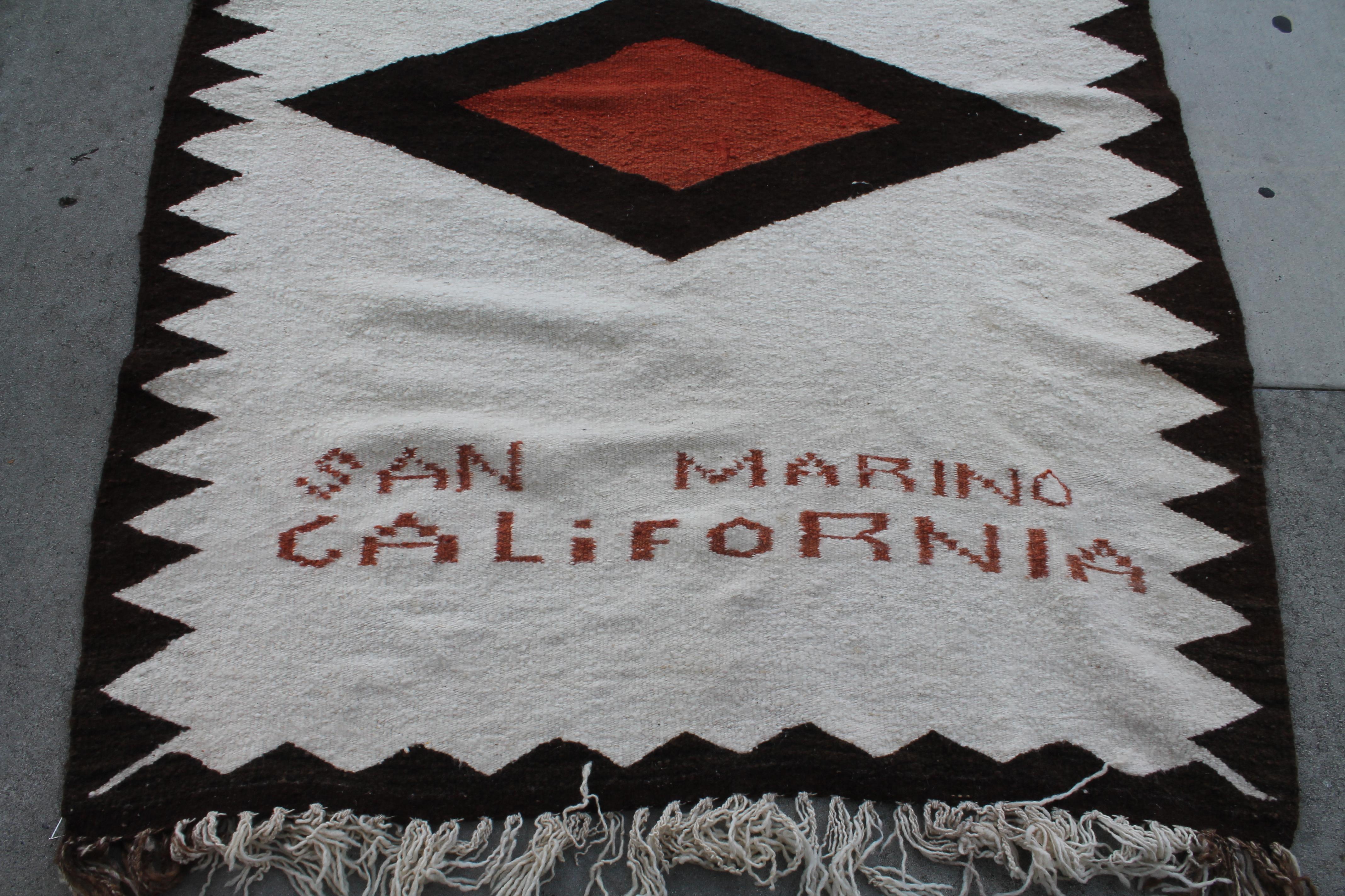 This fine custom made and woven Indian weaving with original fringe and made for Luis Almada in San Marino, California. This is a simple pattern and has a saw tooth inner border. The condition is very good.