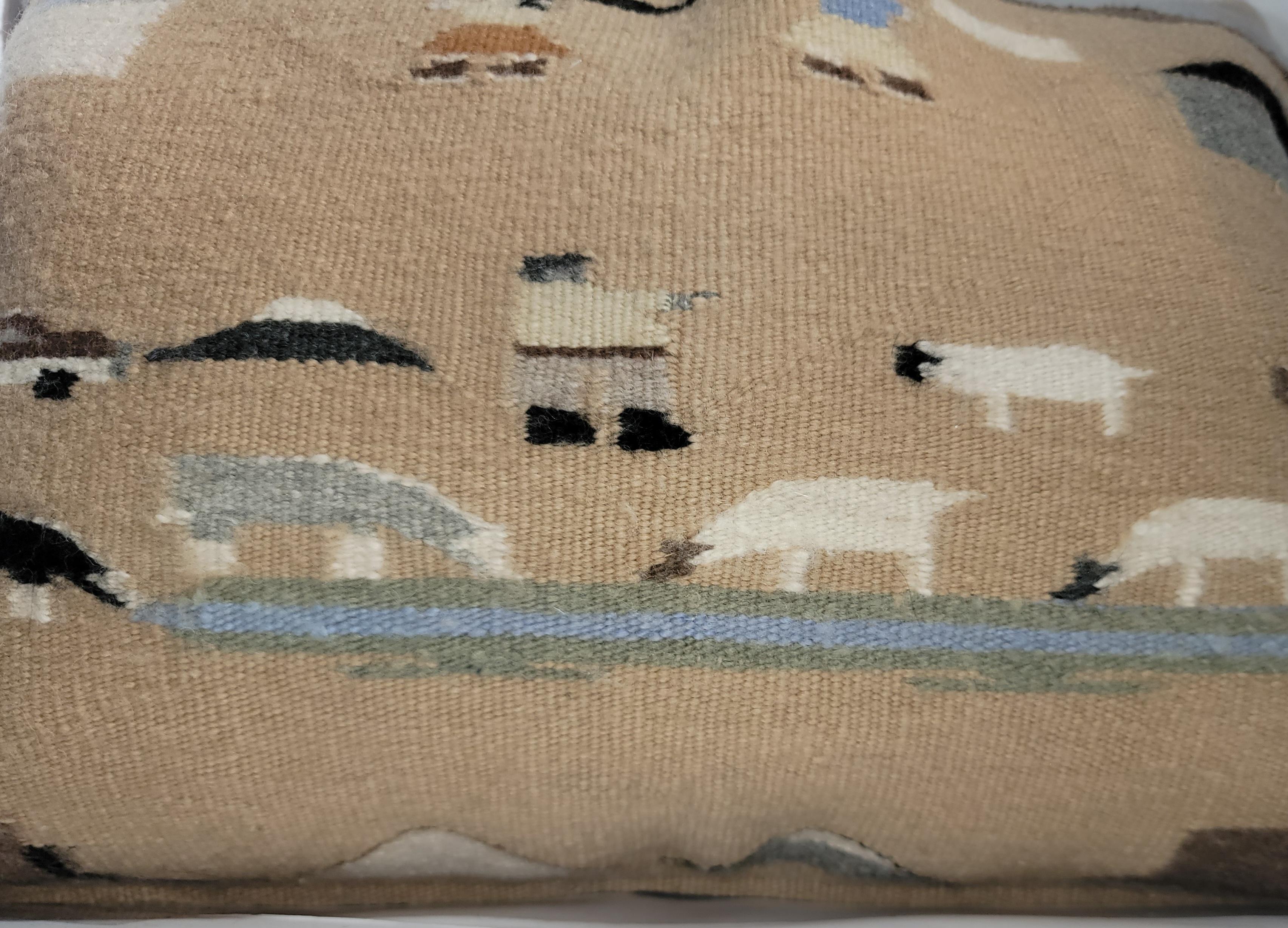 This fun and folky Navajo Indian weaving is in the pictorial format. Made into a amazing pillow with a leather backing.The backing is in a soft tan suede and the insert is down & feather fill.