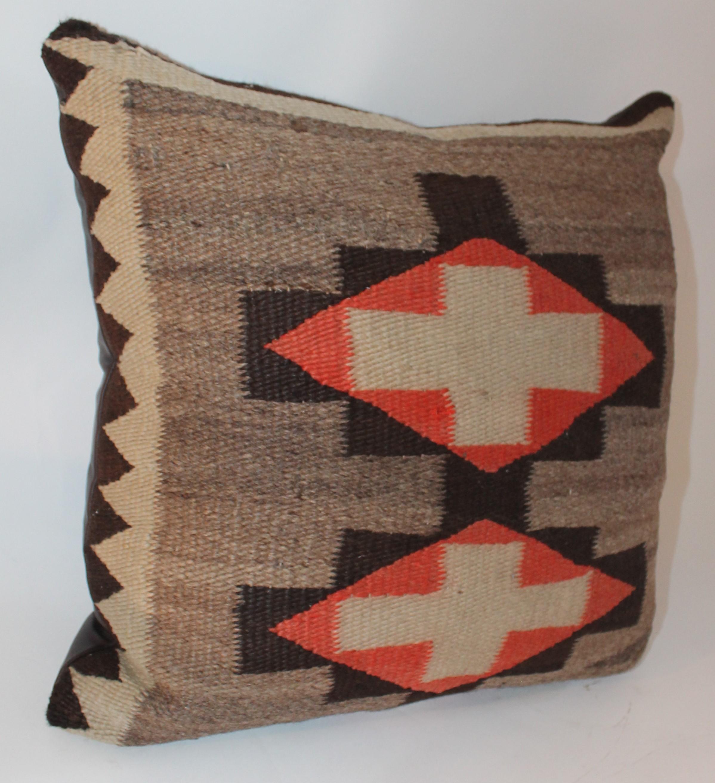 This fine geometric Navajo Indian weaving pillow is from the 19th century. The backing is in very good condition and is in soft brown leather.