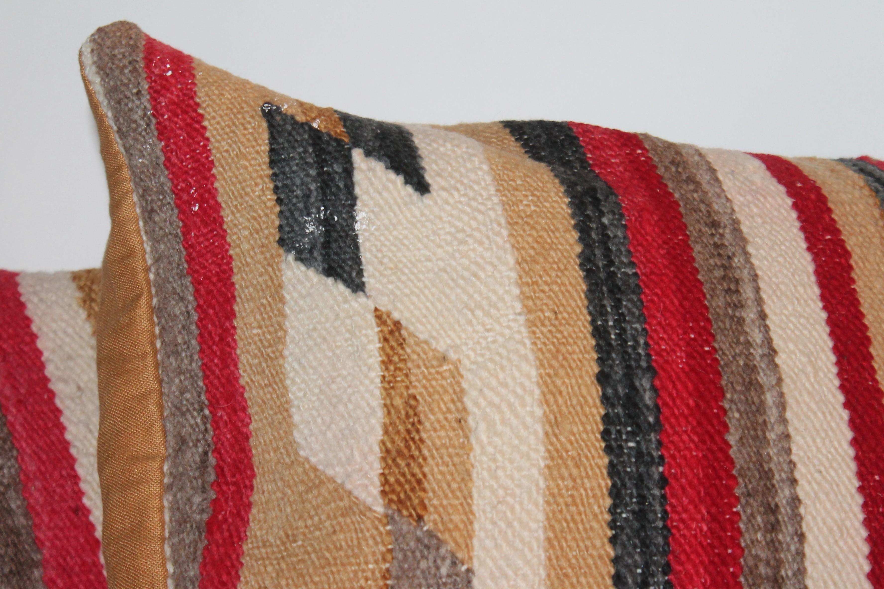 This pair of fantastic early Navajo Indian weaving pillows are in fine condition and have beige cotton linen backings.