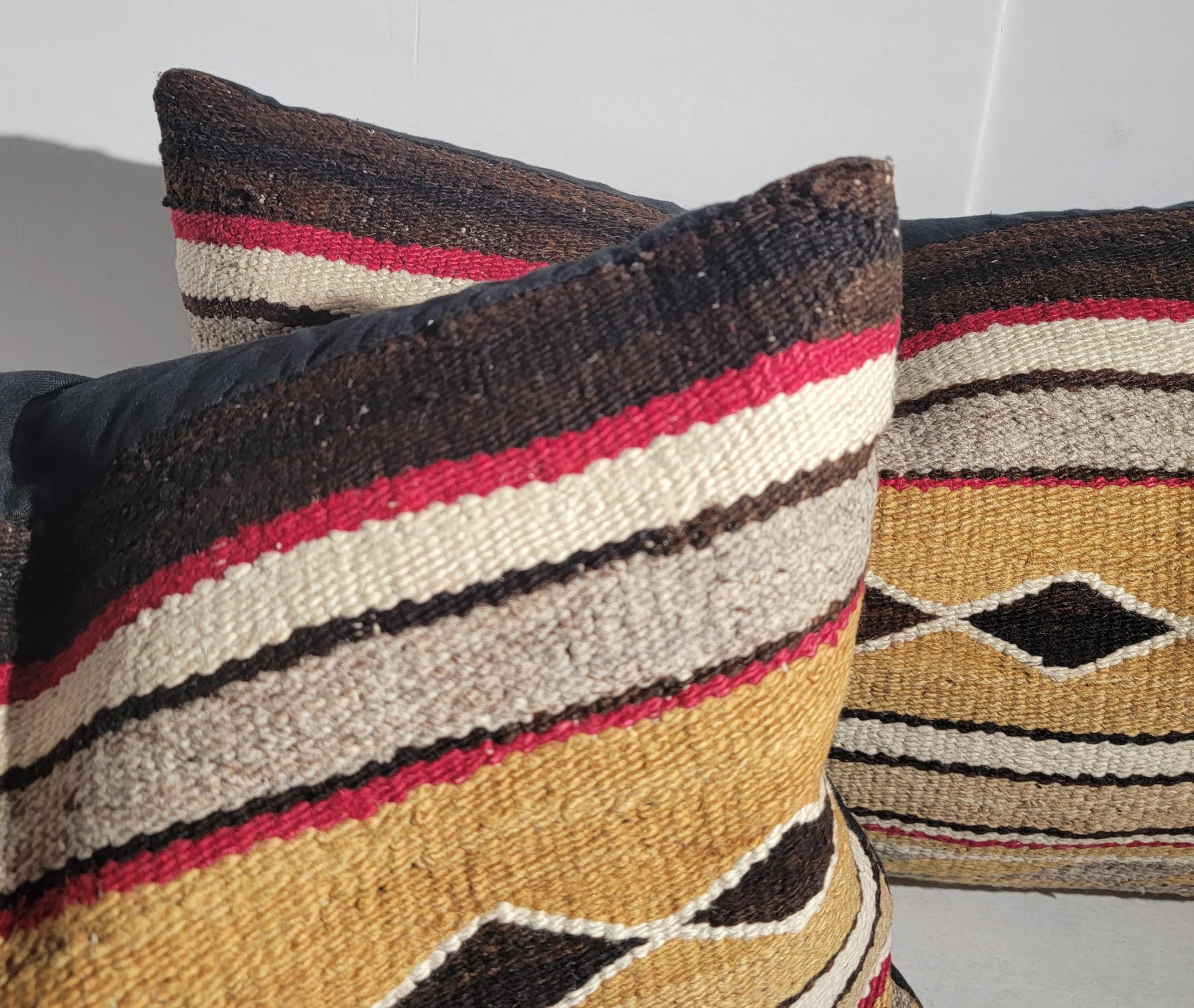 Navajo Indian weaving pillows in fine condition with cotton linen backing.The inserts are down & feather filled. Sold as a pair.