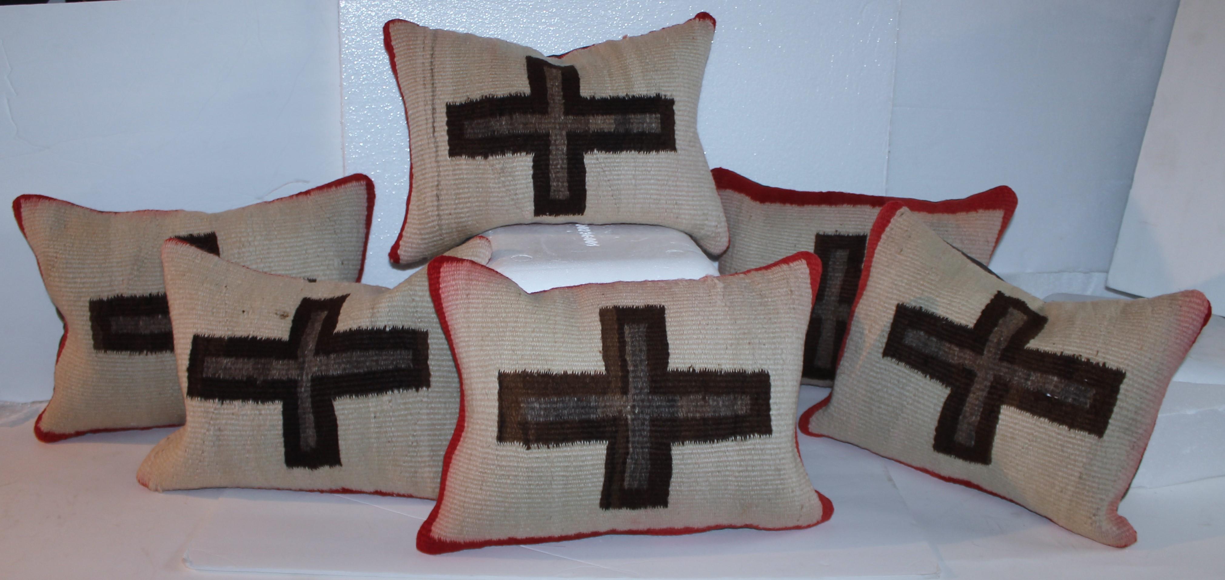 Navajo Indian weaving pillows with brown woven crosses and trimmed in red. The backing is in brown cotton linen. Sold individually or as a collection.The collection of six pillows we can sell for 3895.00 for all of them.