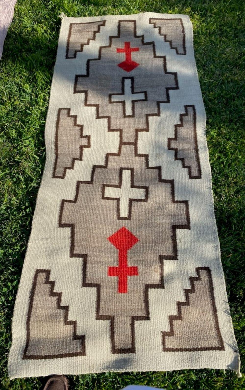 This fine Navajo Runner rug is in fine condition and has crosses and arrows. Amazing size and simple colors.