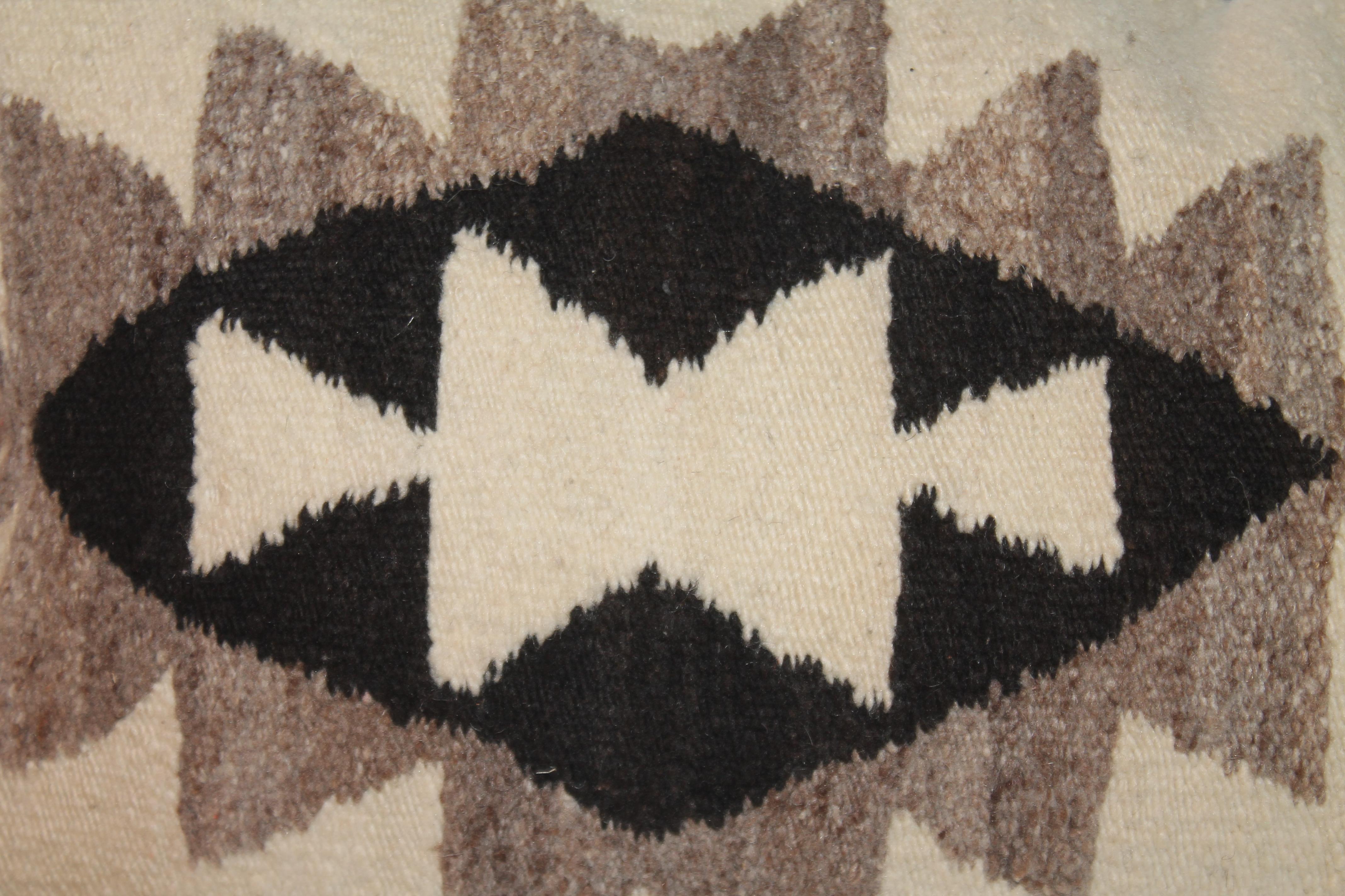 This fine hand woven Indian weaving bolster pillow has a black leather backing and in fine condition. The insert is down & feather fill. This black & cream color is very hard to find in a weaving.