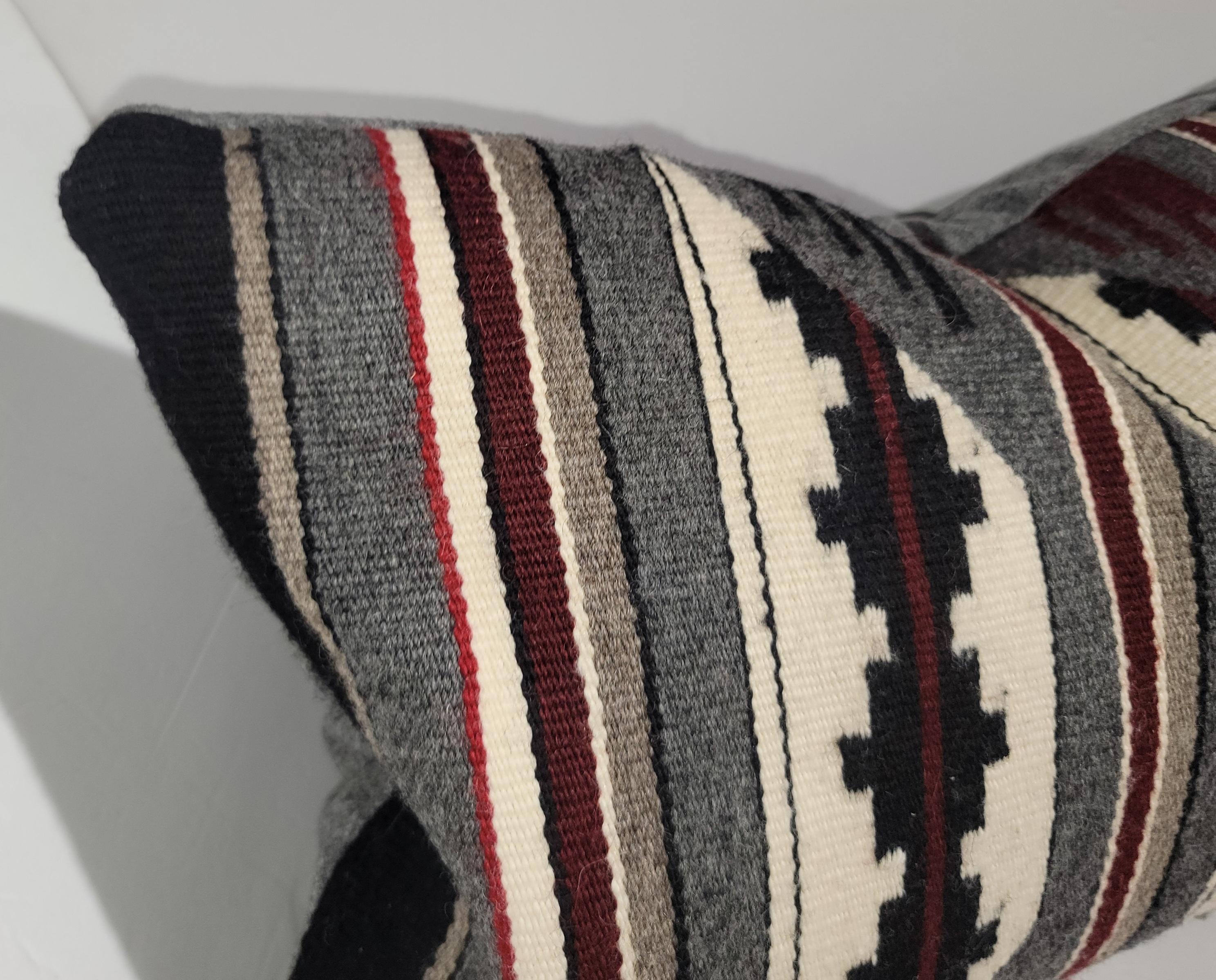 Navajo Indian weaving / saddle blanket bolster pillow.The insert is down & feather fill.The backing is in a charcoal linen fabric.