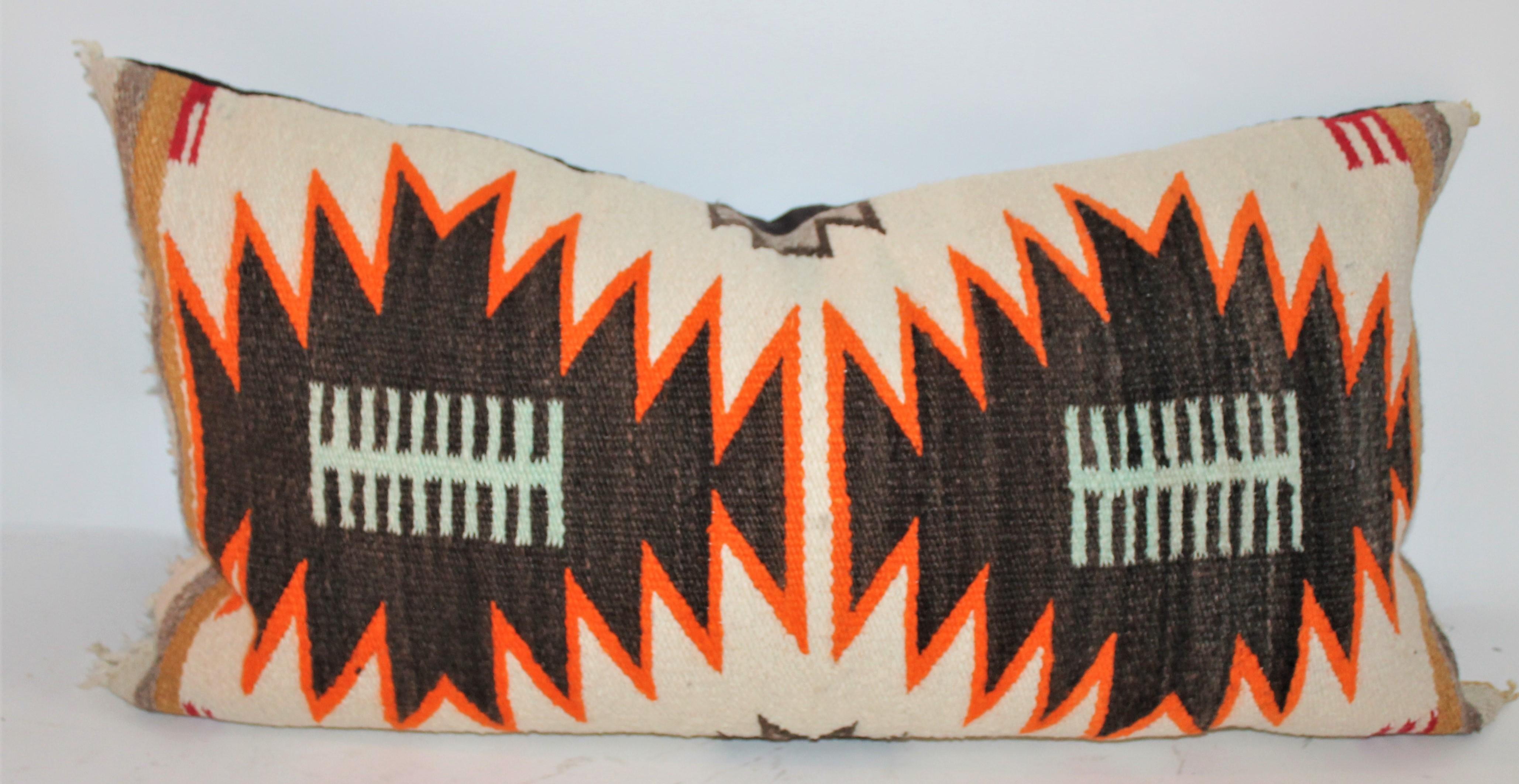 Two different Navajo Indian weaving bolster pillows in fine condition with cotton linen backings. The inserts are down and feather fill.

34 x 17 - larger pillow
34 x 16 - smaller pillow.