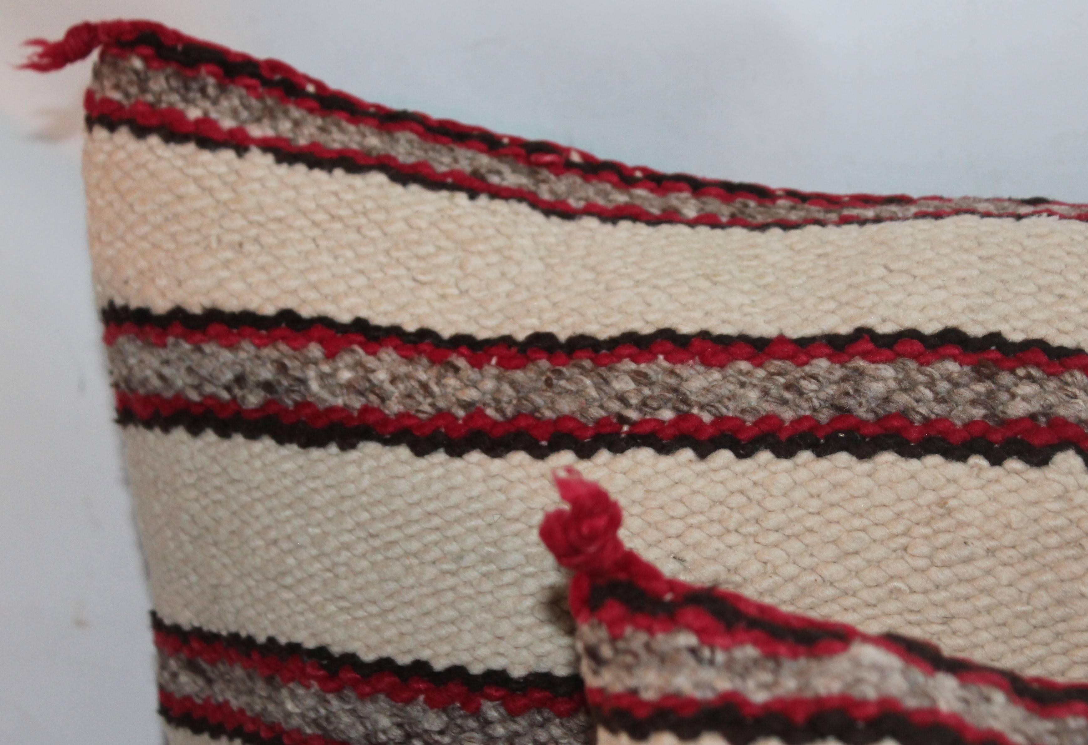 Navajo Indian weaving saddle blanket pillows in great condition. These simple stripes are quite interesting and folky. The backing is in black cotton linen.
