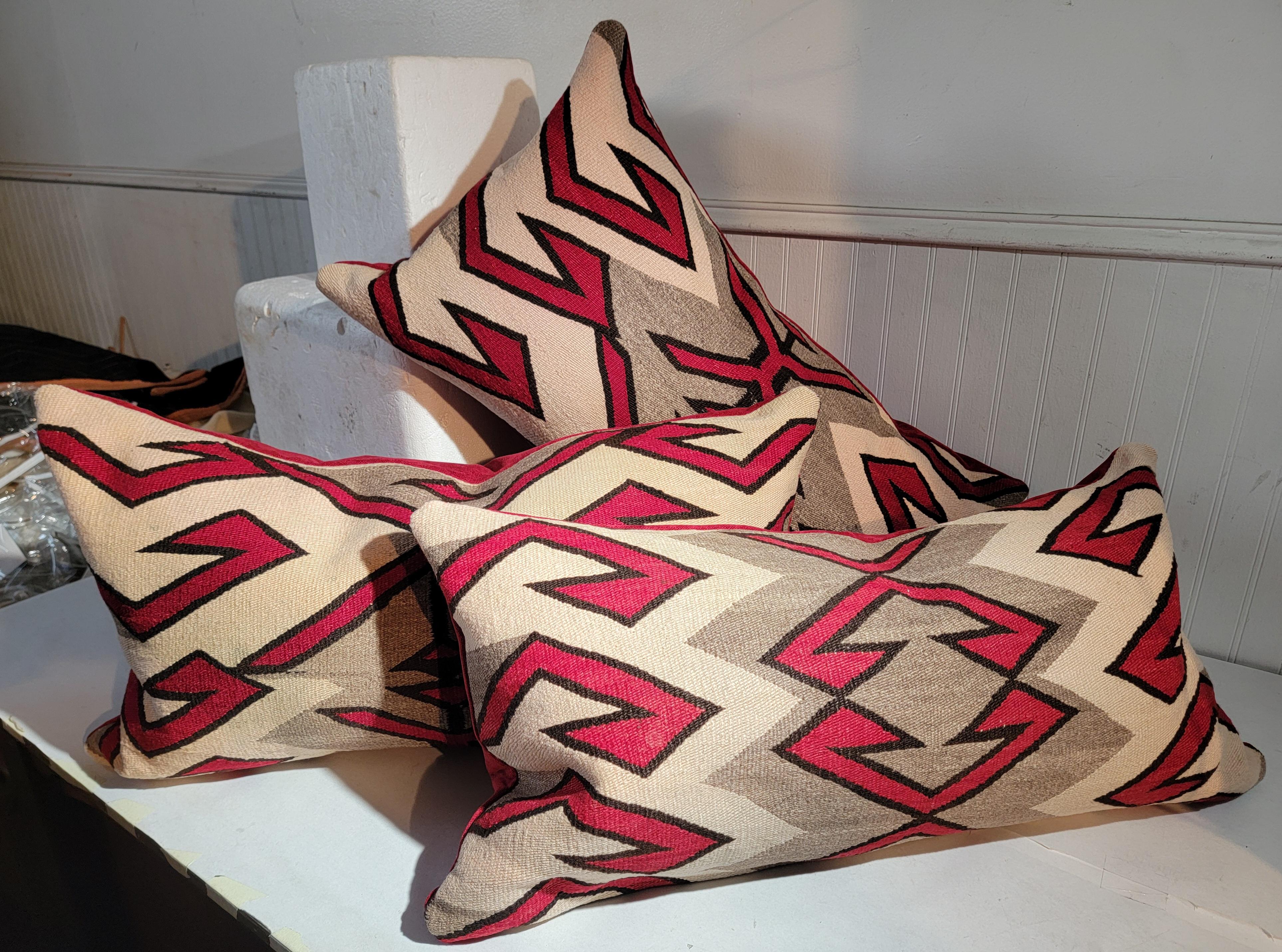 Navajo Indian weaving bolster pillows are in fine condition and are made from a bigger saddle blanket.The colors are the best and condition is very good.The backing is in a soft  red cotton backing. Sold as a collection of three or individually @