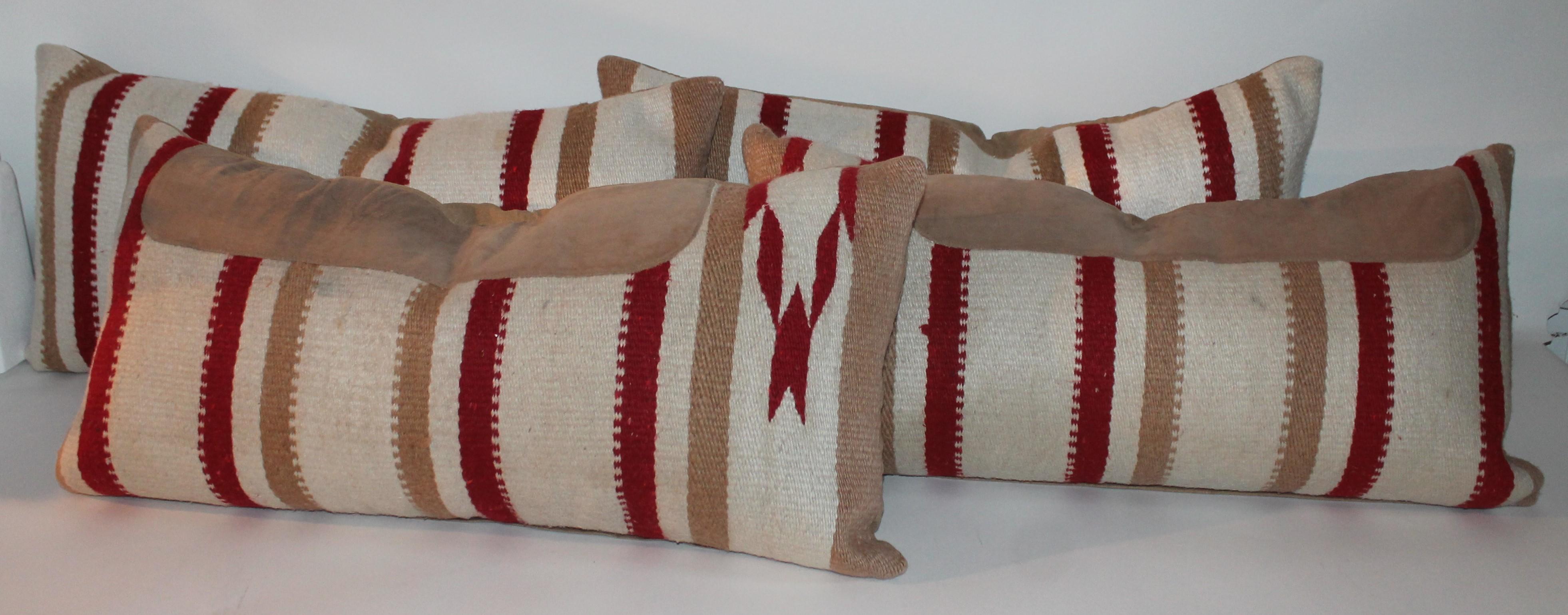 Navajo Indian weaving bolster pillows from a saddle blanket. Two pillows have suede on them and two are without. Two pairs in stock. Two pairs for 1895, for all four.