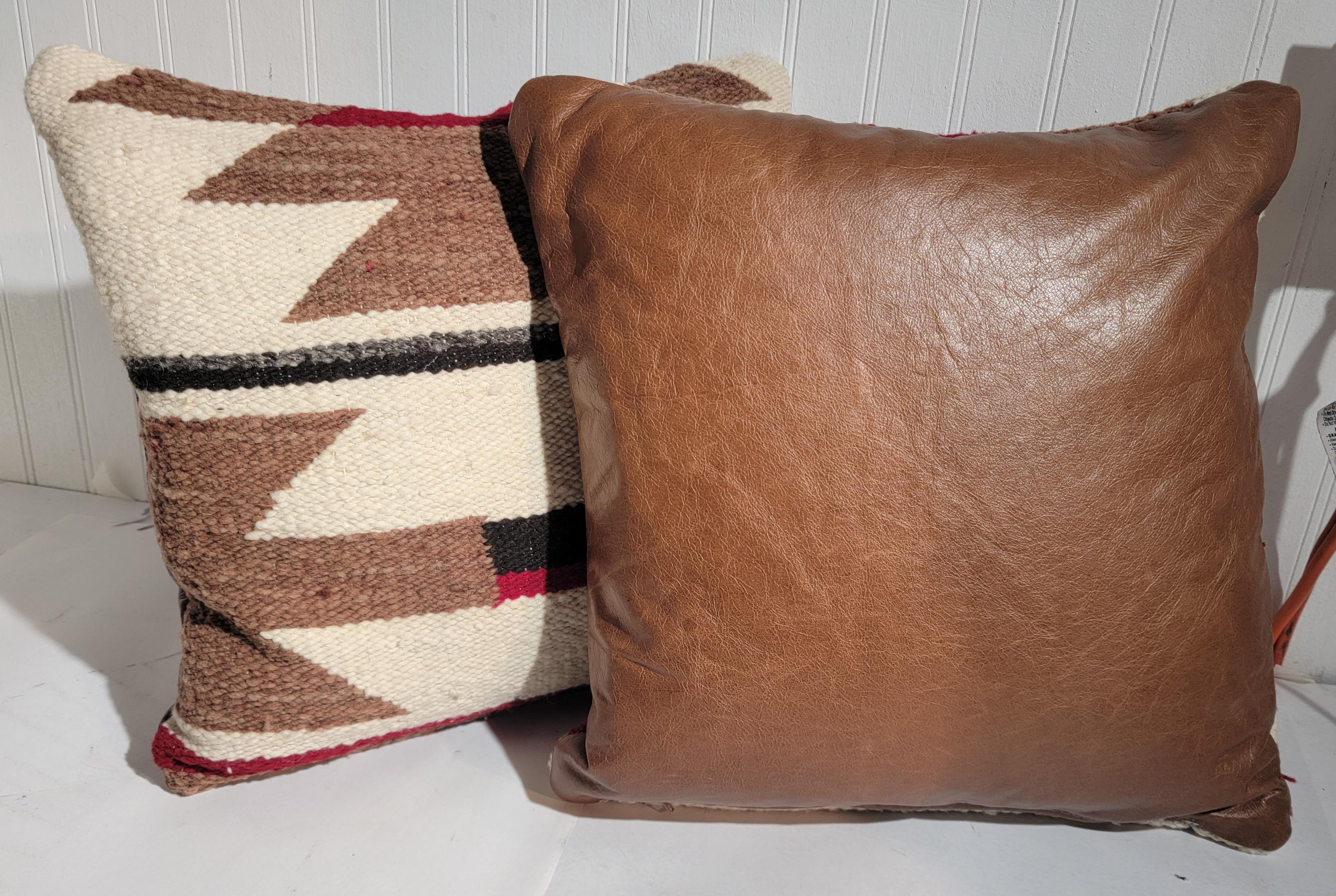 These Navajo Indian weaving pillows have fine leather backings and in very good condition.Sold as a pair only.