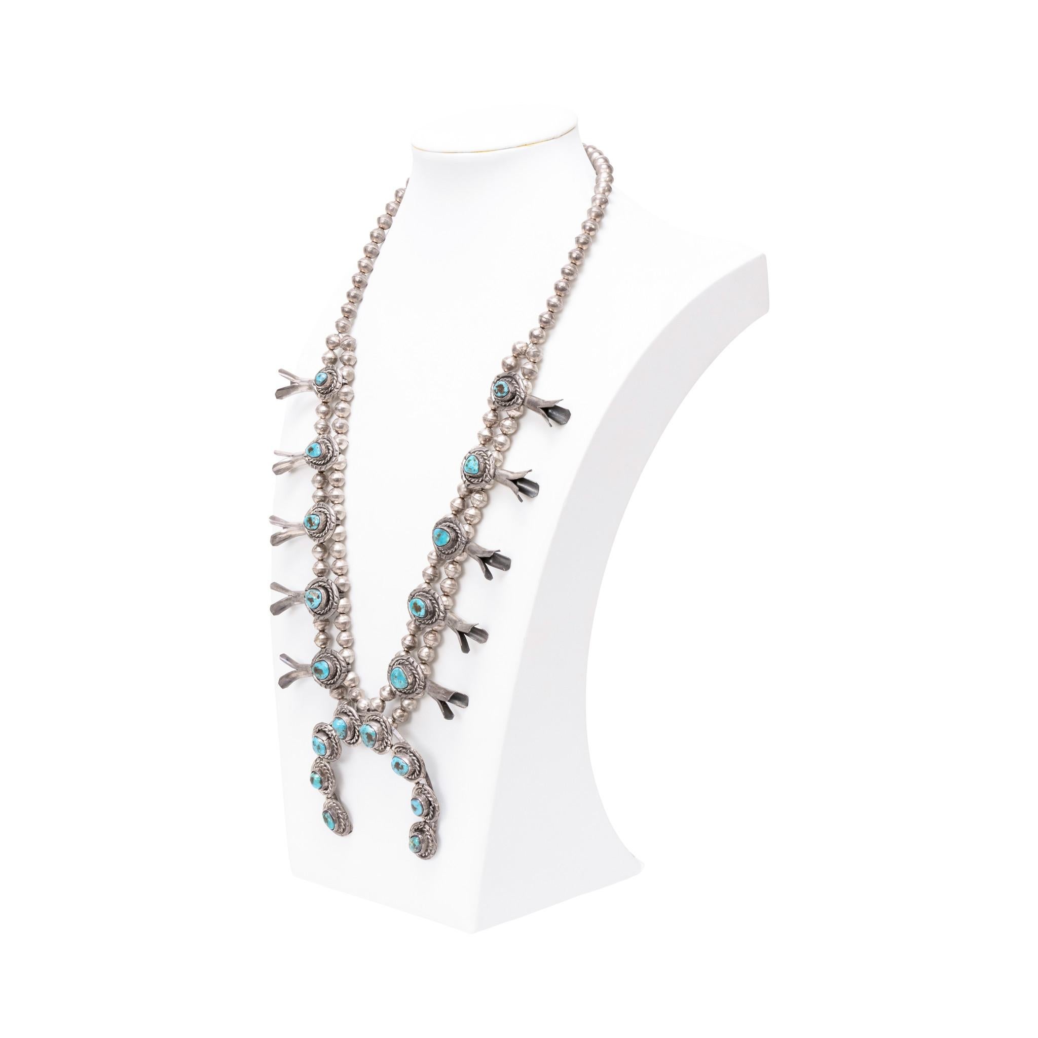 Navajo squash blossom with Kingman turquoise. Featuring 18 beautiful bright blue stones with dark matrix. Each stone surrounded by twisted rope border. Simple piece, great for casual wear alone or layered with other pieces. Late 20th century.  Old
